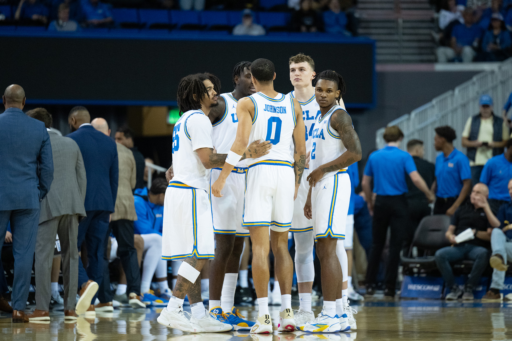 The Bruins gather for a team huddle. (Aidan Sun/Assistant Photo editor)