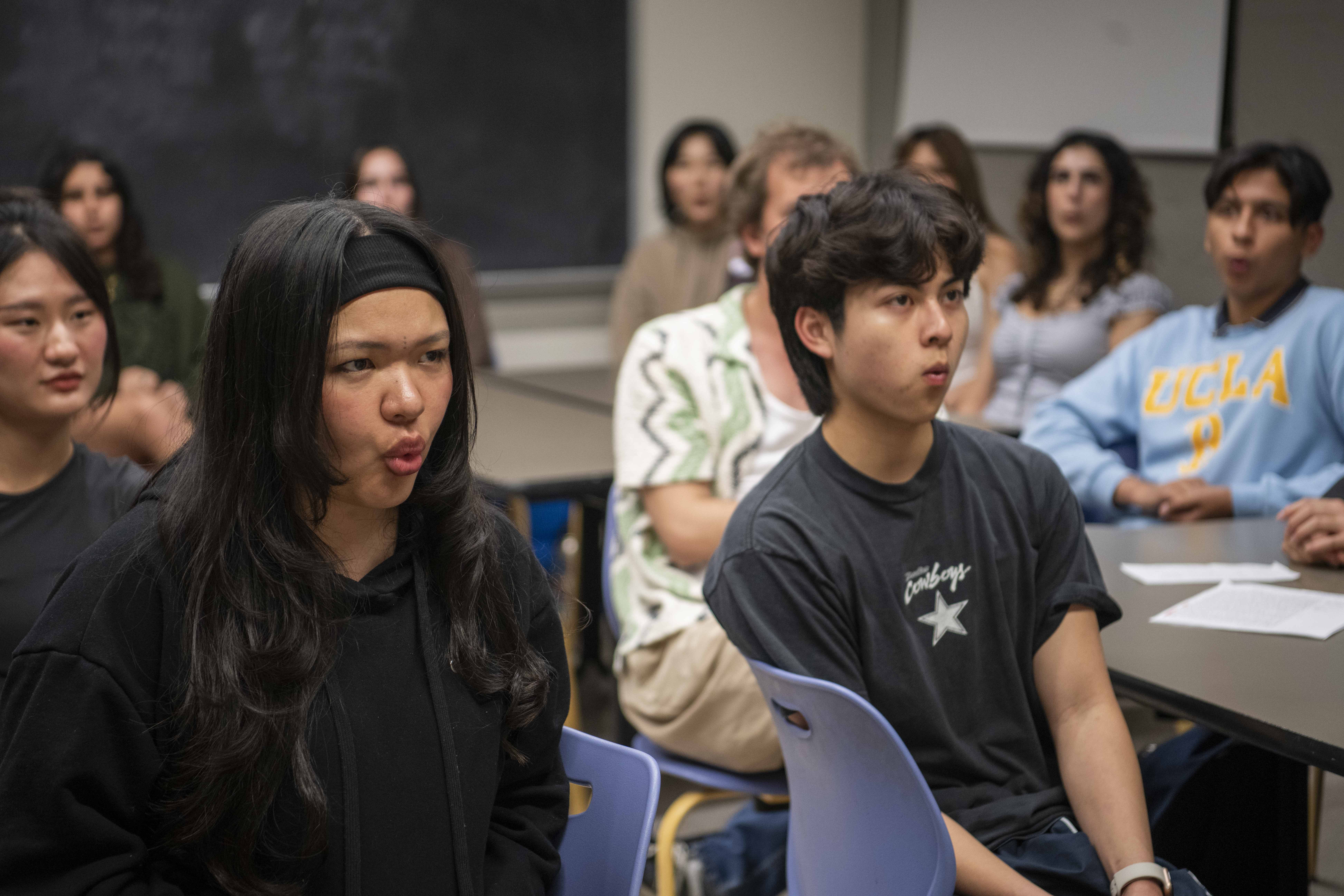 Members of the Whistling Club at UCLA sit in a classroom and practice their whistling. The club has released multiple Instagram Reels including one performing Lady Gaga and Bruno Mars&squot; "Die With A Smile" that has received almost 1 million views. (Andrew Diaz/Daily Bruin)