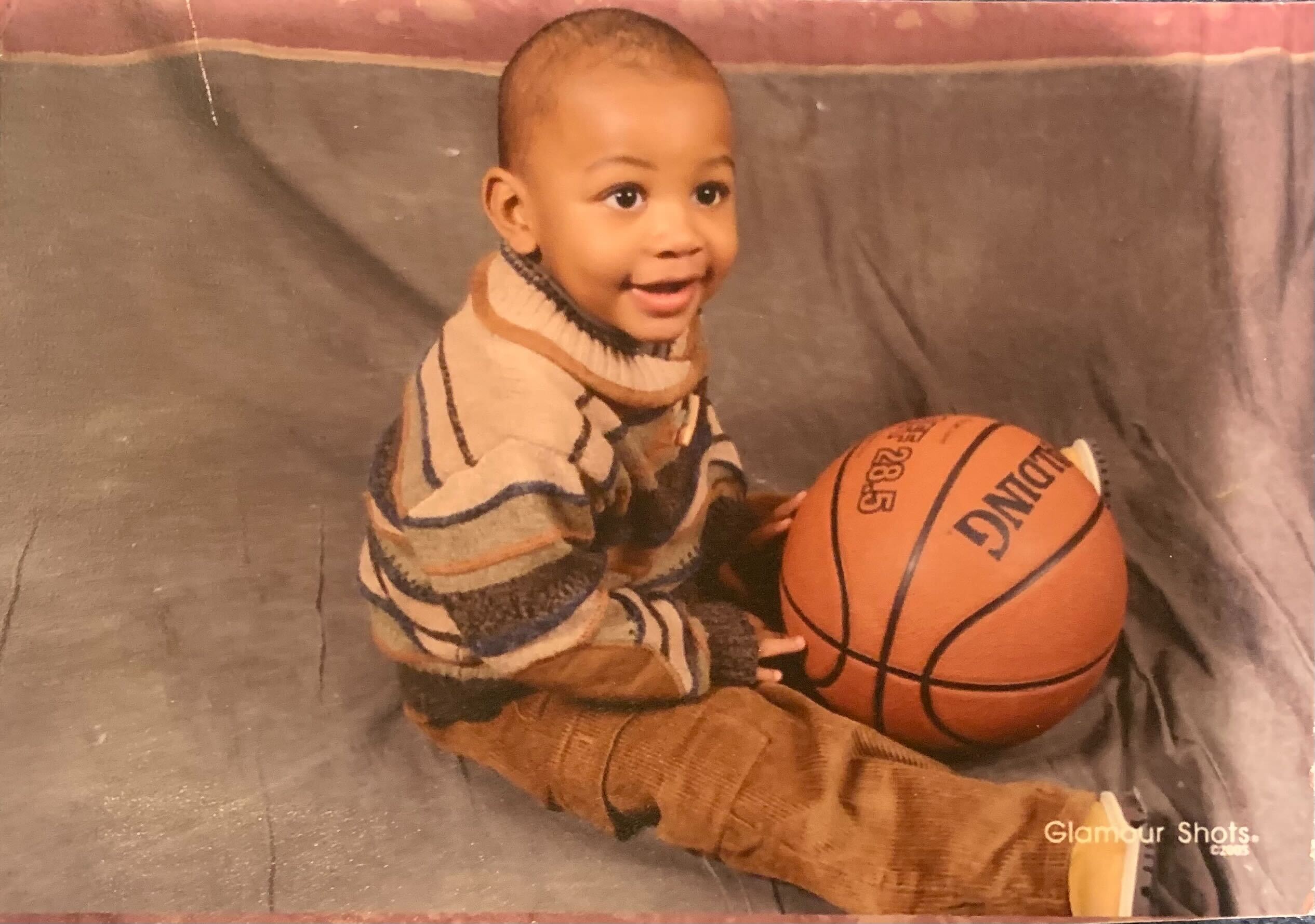 UCLA men's basketball sophomore guard Sebastian Mack holds a basketball as a baby. (Courtesy of Leslie Johnson)