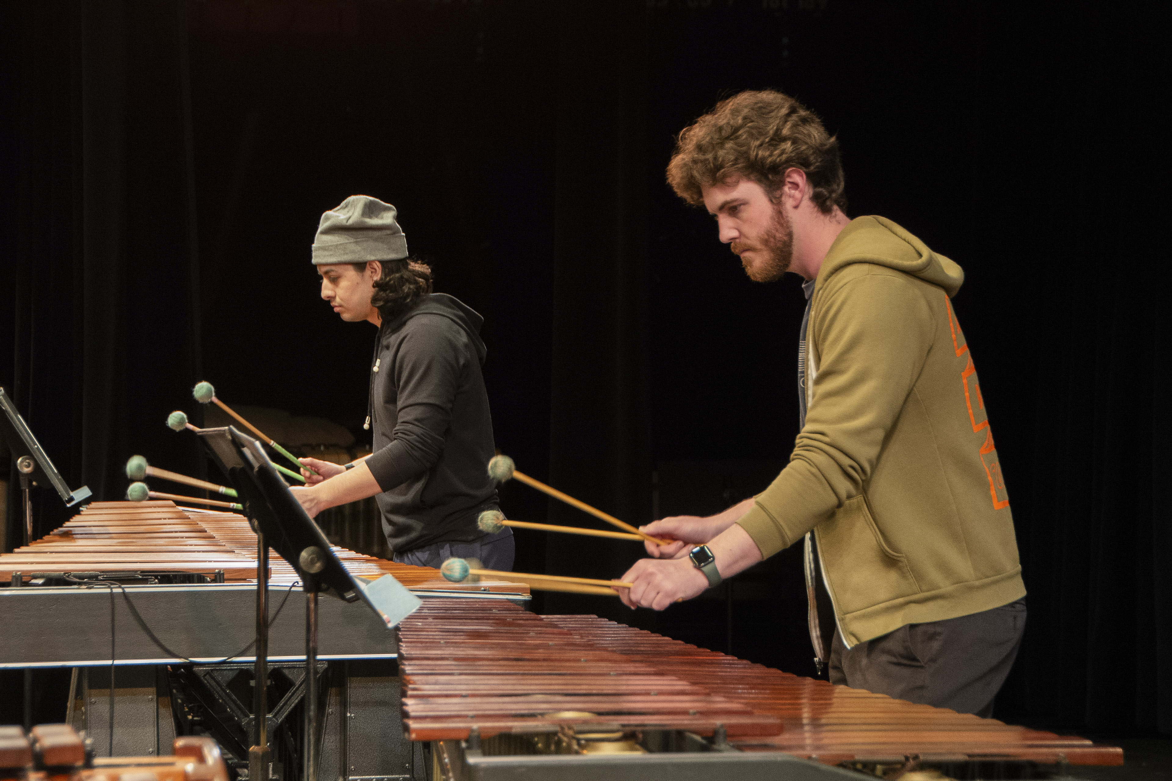 A student wearing a gray beanie and a student wearing a green jacket perform during a past event held by the UCLA Percussion Ensemble. The group's performance at Schoenberg Hall on Monday was coordinated by percussion performance lecturer Theresa Dimond. (Courtesy of The UCLA Herb Alpert School of Music)