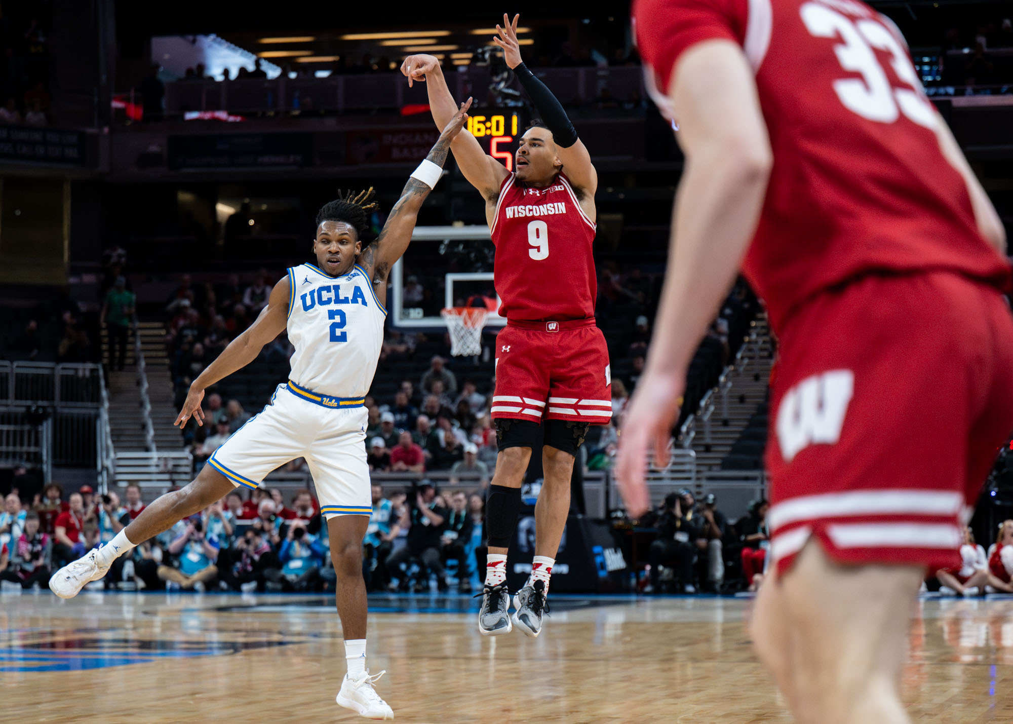 Wisconsin guard John Tonje rises over UCLA junior guard Dylan Andrews for a 3. (Aidan Sun/Assistant Photo editor)