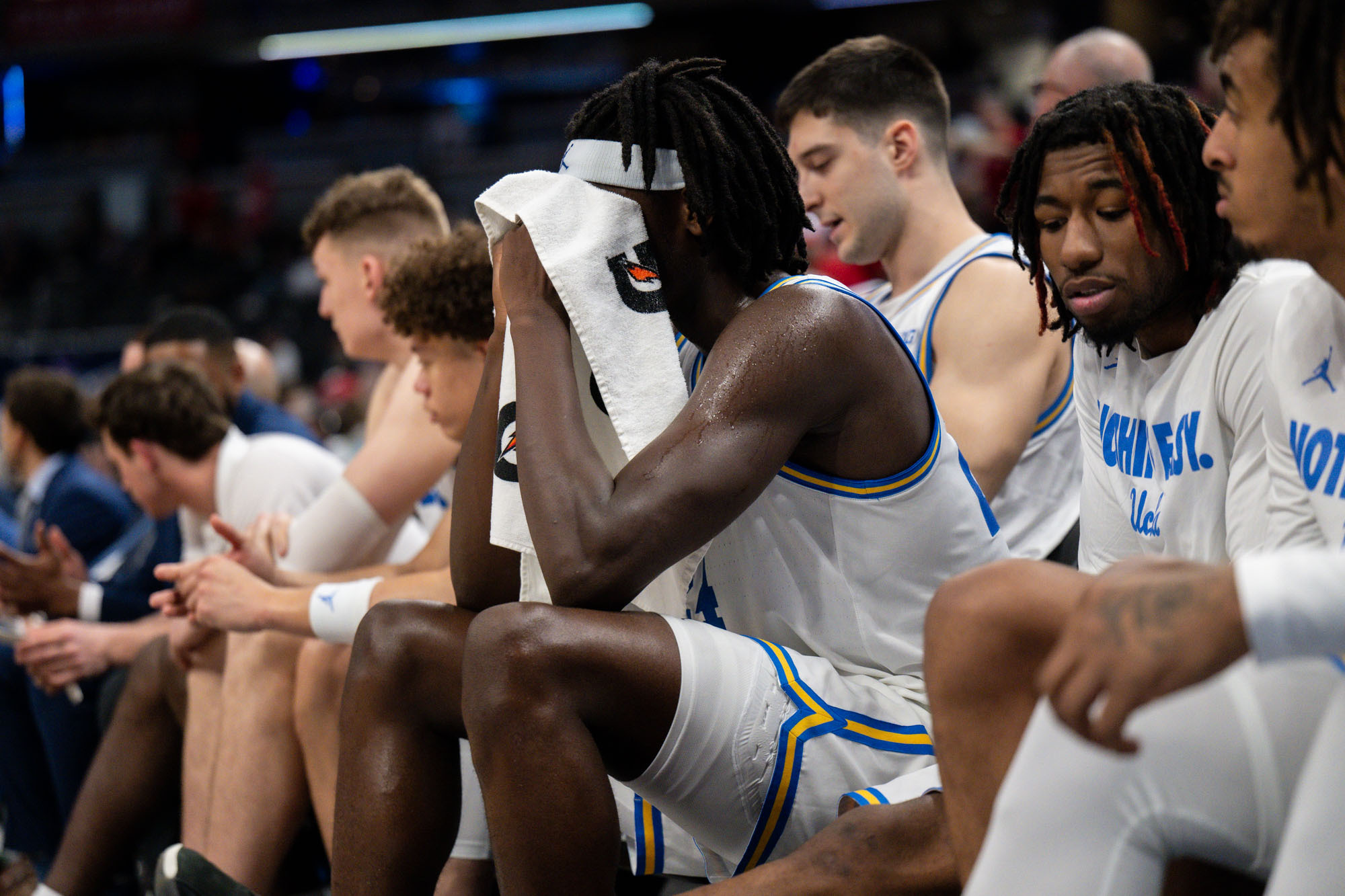 Junior forward William Kyle III holds his head in a towel on the bench. (Aidan Sun/Assistant Photo editor)