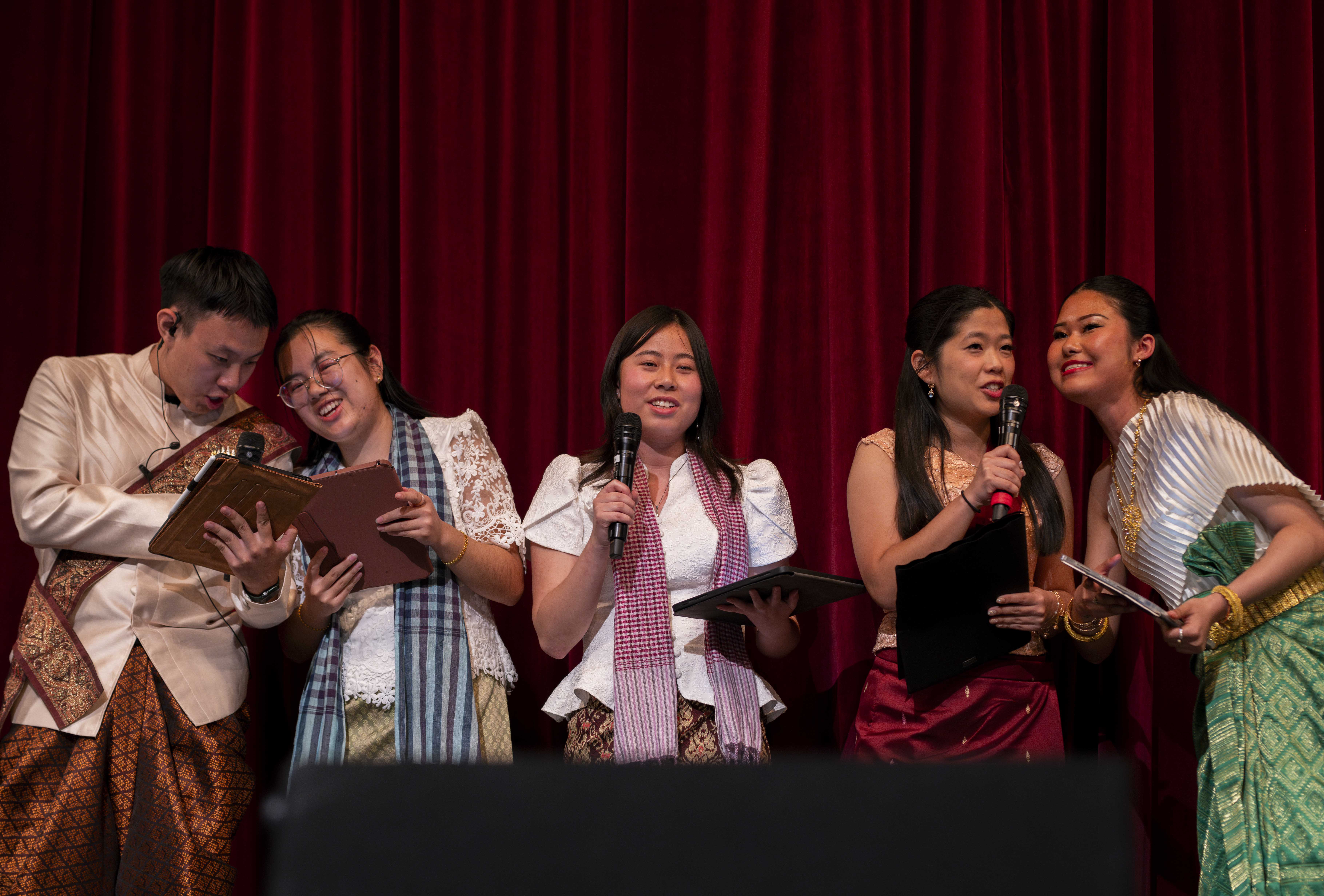 The executive board for the United Khmer Students' Culture Night speak into microphones while opening the 27th annual event, which was held at Schoenberg Hall on Saturday. The event included music, an original play and traditional dancing to express the Khmer experience. (Anna Dai-Liu/Daily Bruin senior staff)