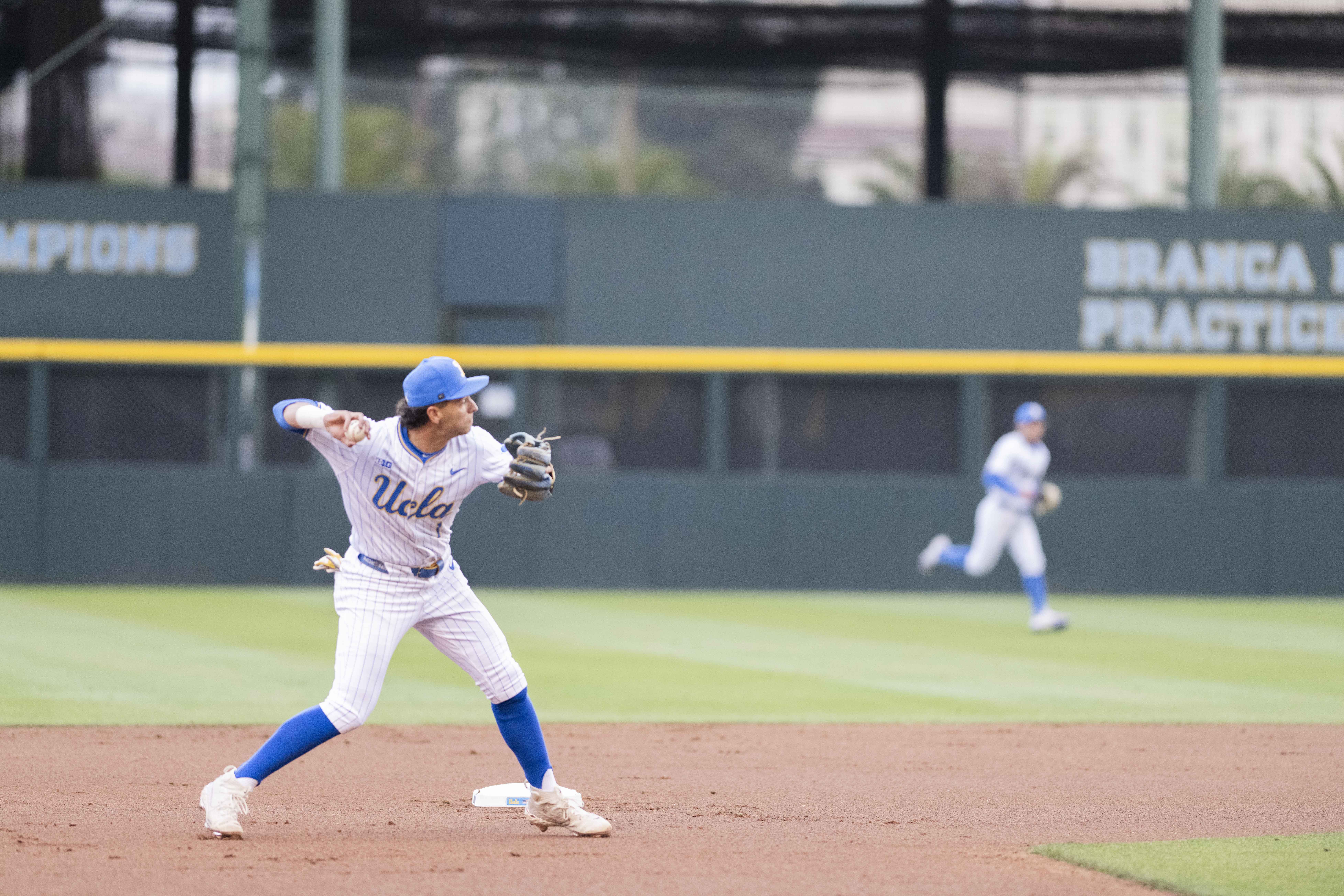 Sophomore shortstop Roch Cholowsky throws a baseball toward first. (Rylan Riccabona/Daily Bruin)