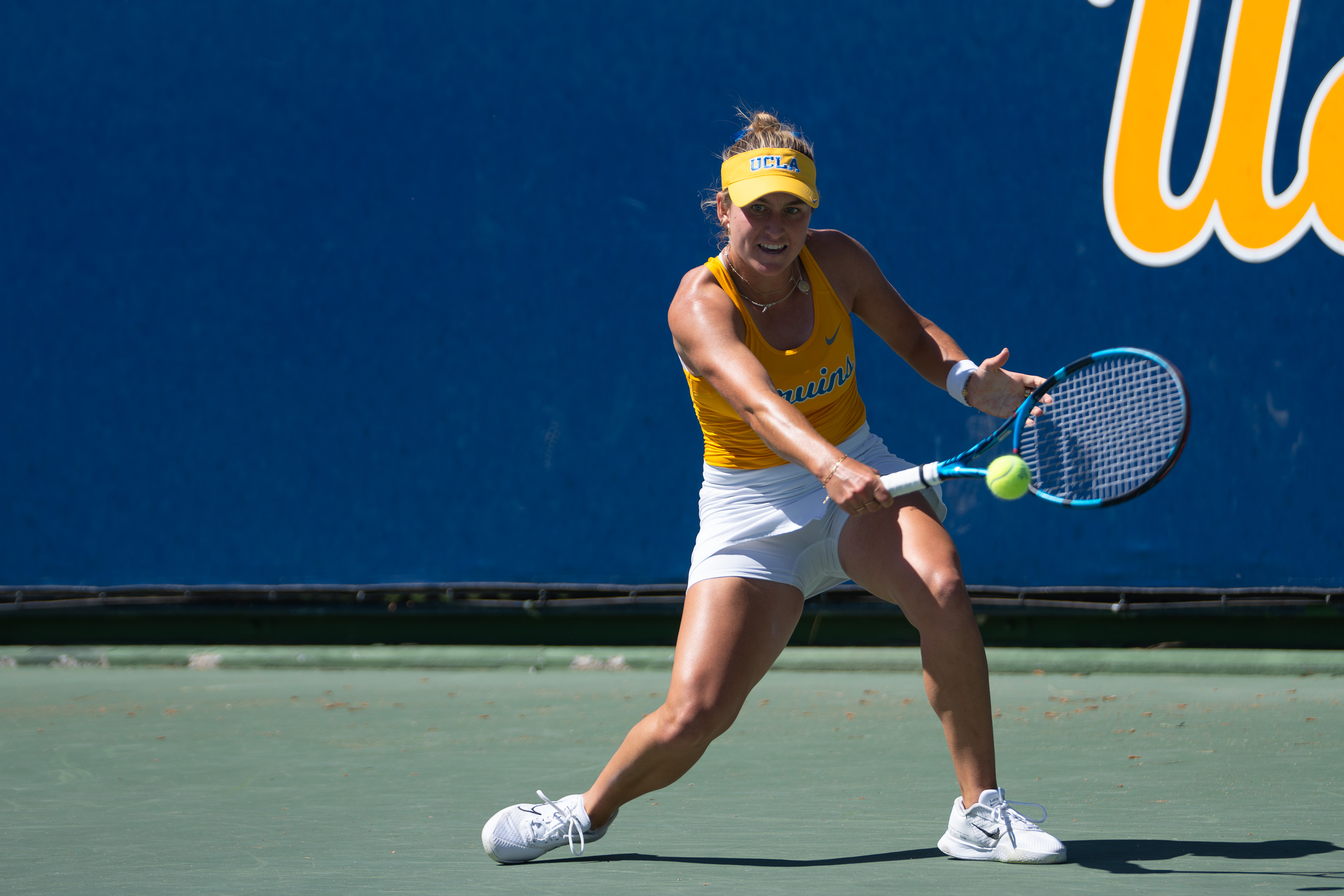 No. 22 Anne-Christine Lutkemeyer backhands a ball at the Los Angeles Tennis Center. (Aaron Fang/Daily Bruin)