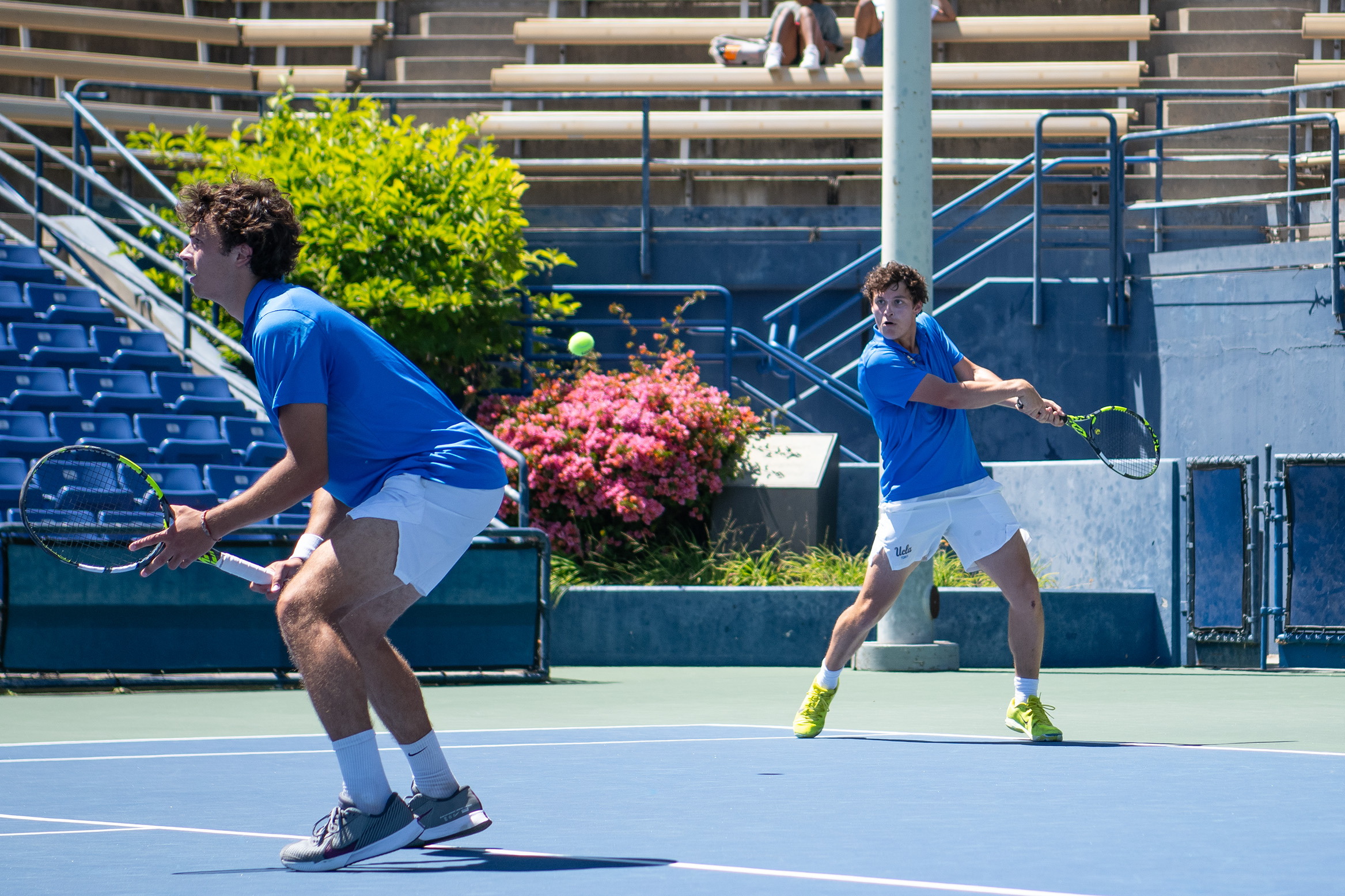 Seniors Giacomo Revelli (left) and Alexander Hoogmartens (right) play doubles at the Los Angeles Tennis Center. (Elizabeth Murray/Daily Bruin)