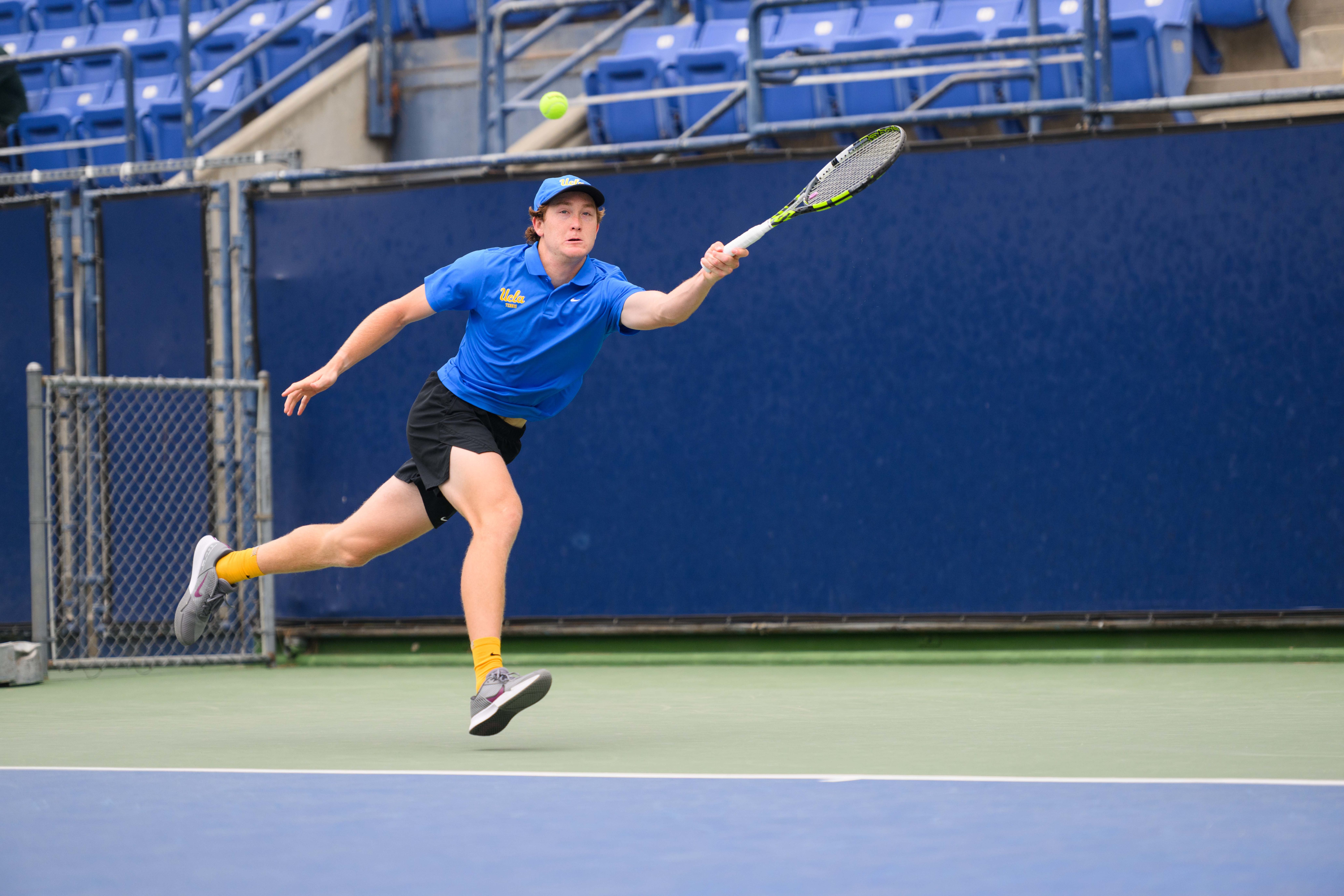 No. 35 sophomore Spencer Johnson races to his left as he forehands a return. (Brianna Carlson/Daily Bruin staff)