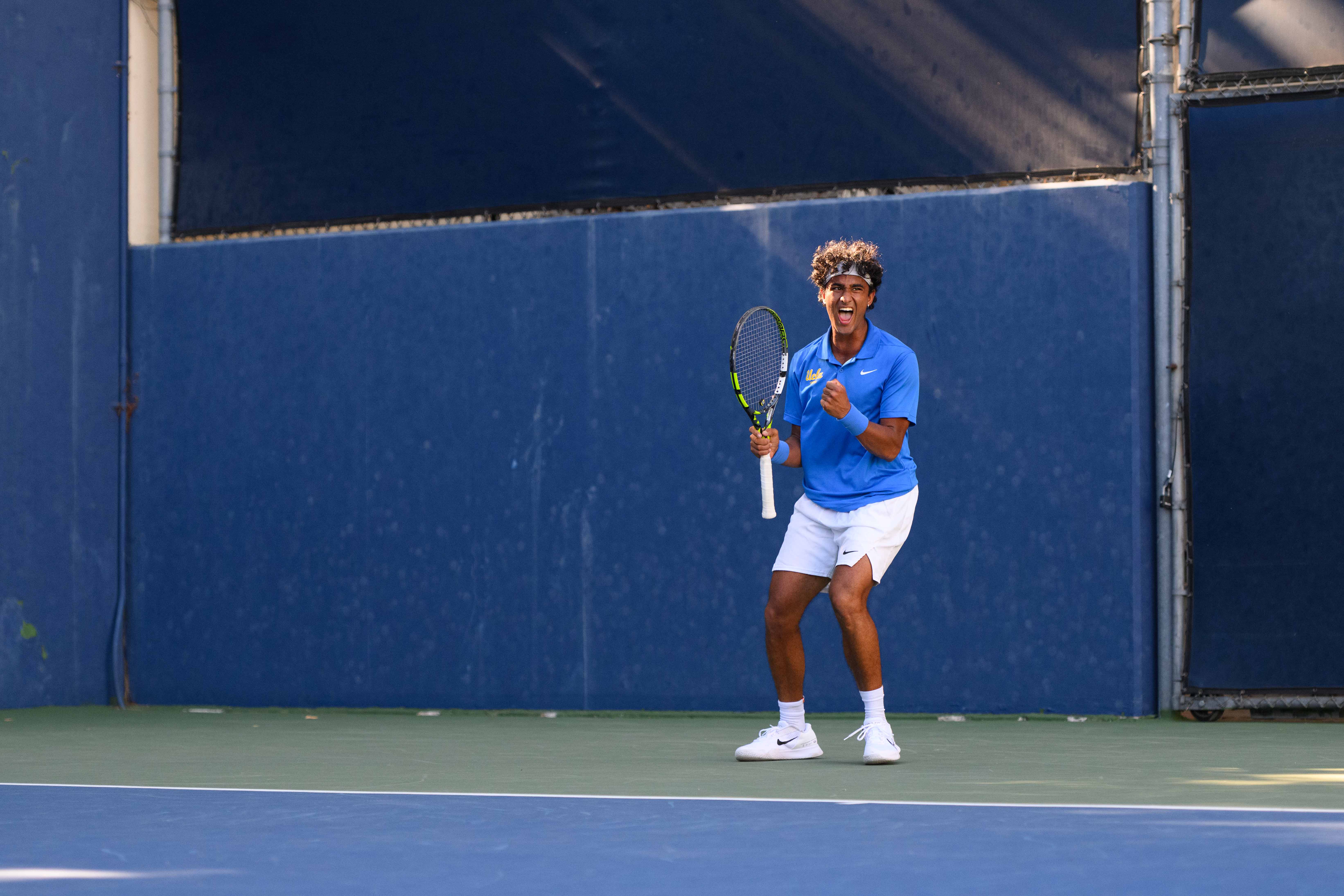 No. 116 junior Aadarsh Tripathi celebrates at the Los Angeles Tennis Center. (Brianna Carlson/Daily Bruin staff)