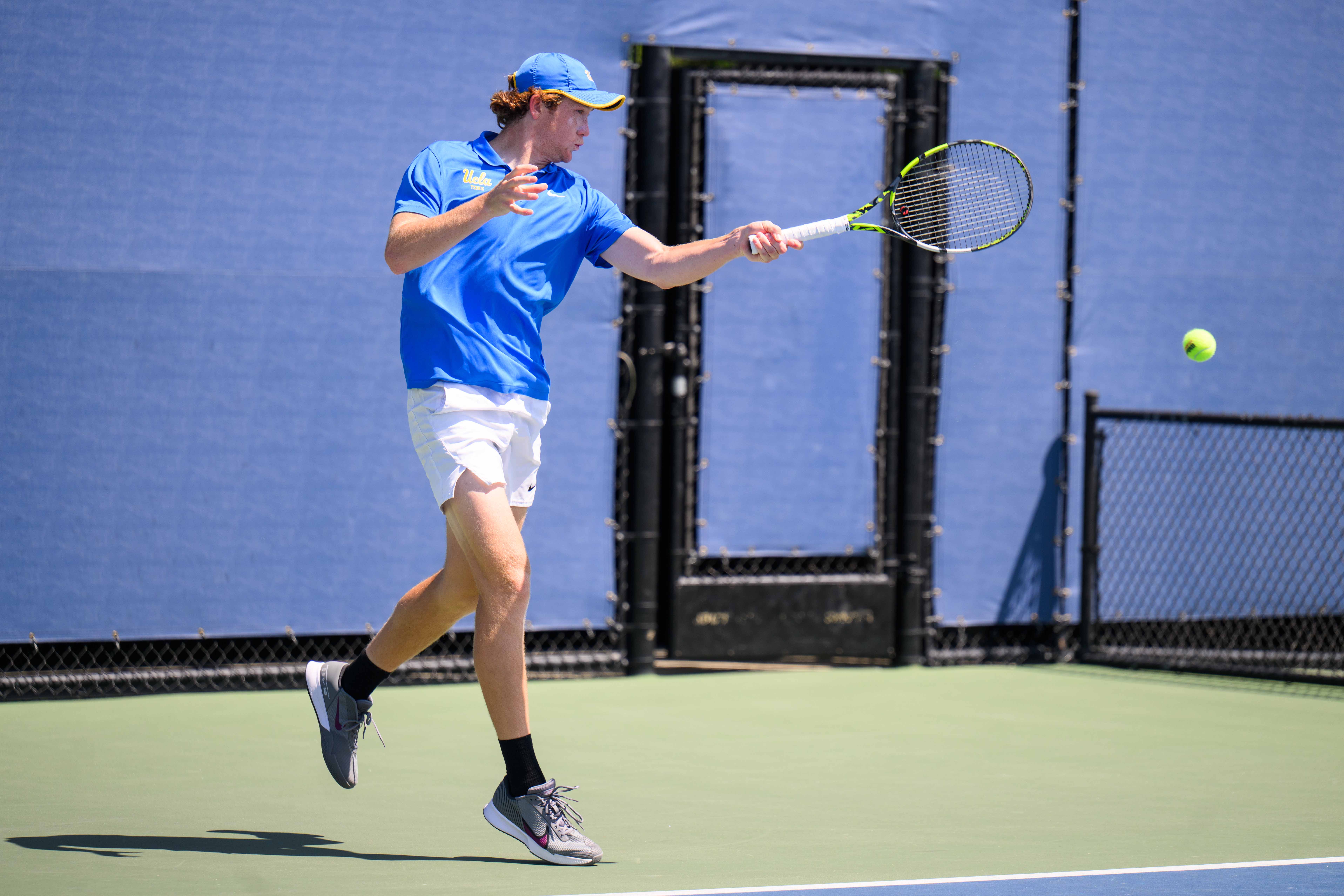No. 35 sophomore Spencer Johnson returns a ball with a forehand. (Edward Ho/Daily Bruin)