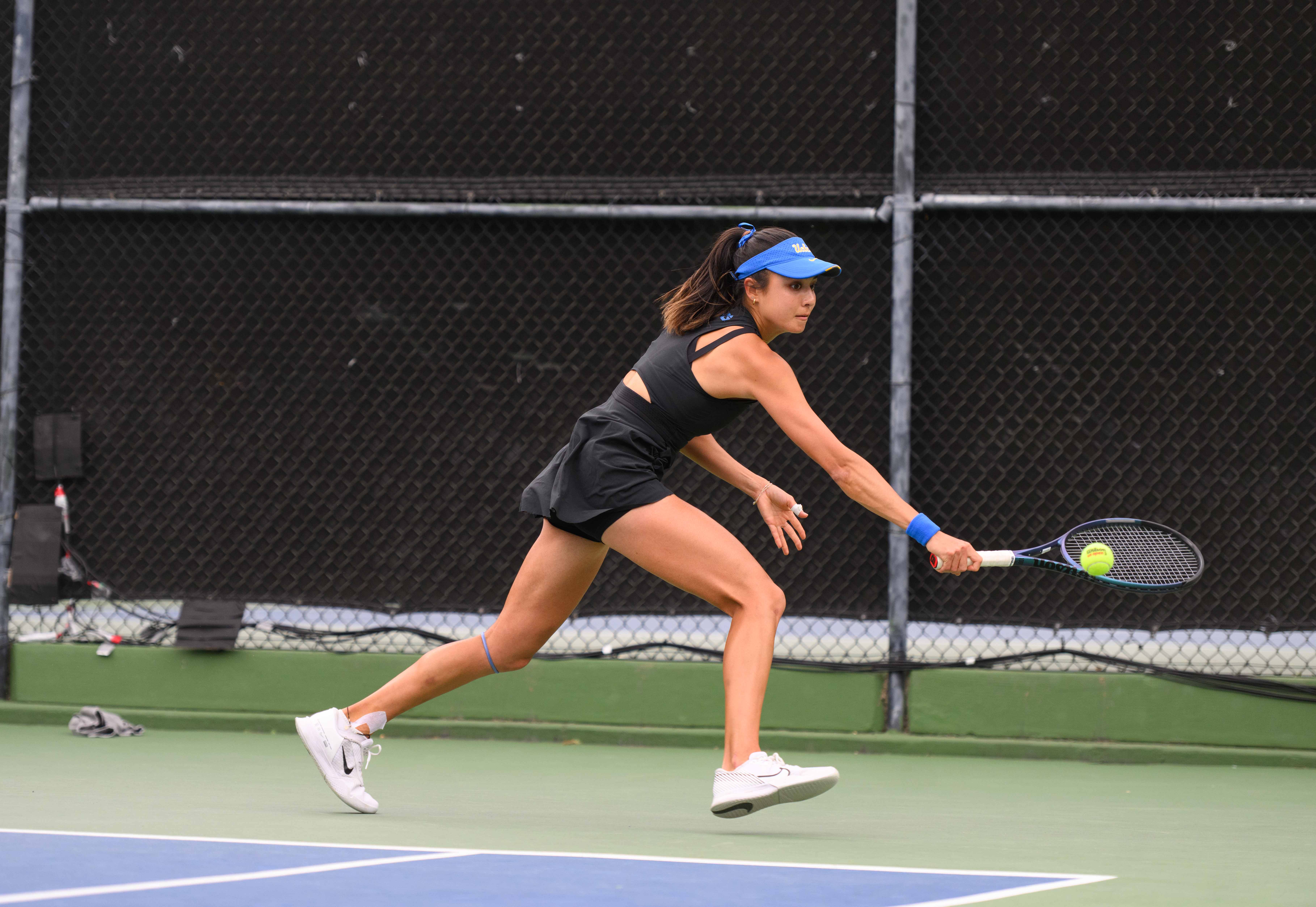 No. 62 senior Elise Wagle races to the back corner of the sideline to backhand a ball. (Brianna Carlson/Daily Bruin staff)