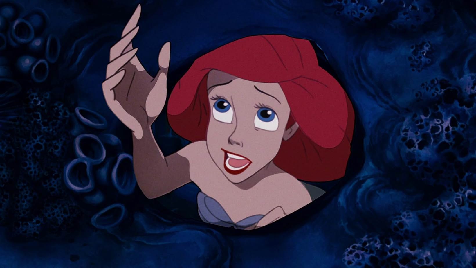 Ariel reaches her right hand upward in a scene from Disney&squot;s 1989 animated film "The Little Mermaid." The mermaid protagonist&squot;s ballad "Part of Your World" was sung by Jodi Benson in the film. (Courtesy of IMDb and Walt Disney Animation Studios)