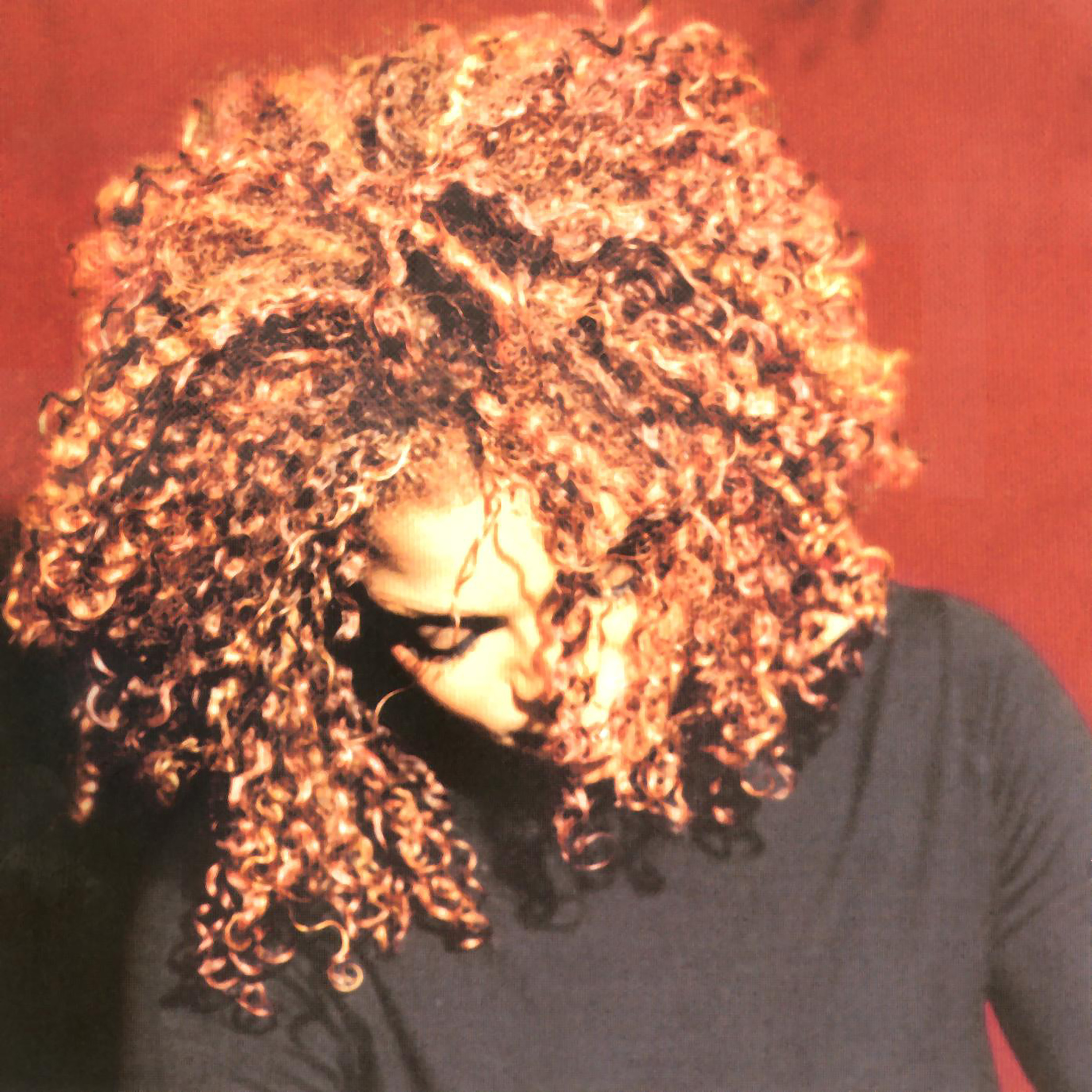 With her hair styled in tight red curls, Janet Jackson looks downward while wearing a black top on the cover of her 1997 album "The Velvet Rope." The 75-minute LP expanded the thematic scope of Jackson&squot;s music with songs touching upon topics ranging from depression to queerness to BDSM. (Courtesy of Virgin Records and Black Doll Inc, under exclusive license to UMG Recordings, Inc.)