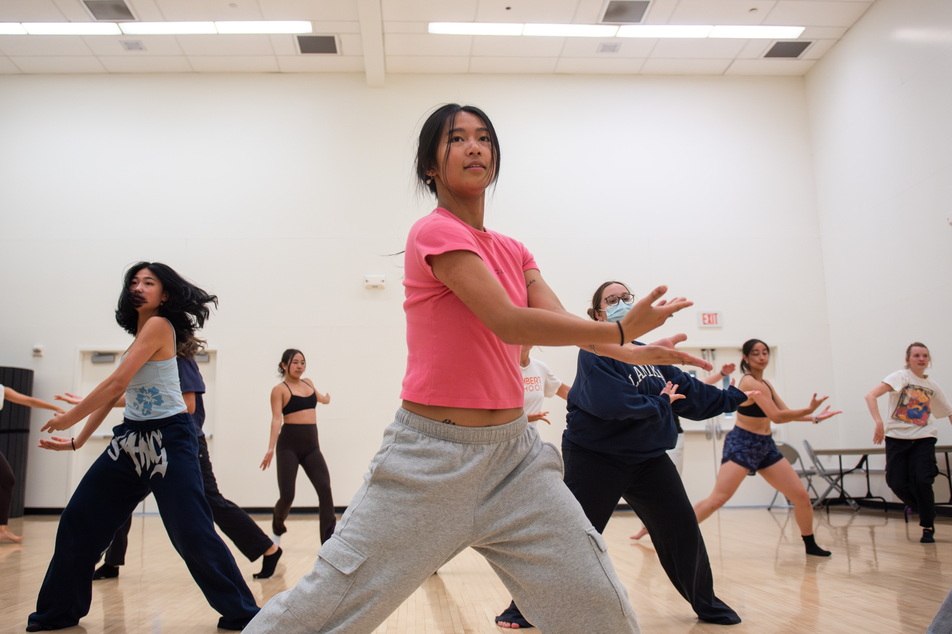 Members of Synthesis Dance stretch out their arms while practicing choreography in a room in the John Wooden Center. Fourth-year economics student Katy Palmer said the troupe's Spring Sing performance will include themes of female empowerment and the team relationships. (Jeannie Kim/Daily Bruin senior staff)