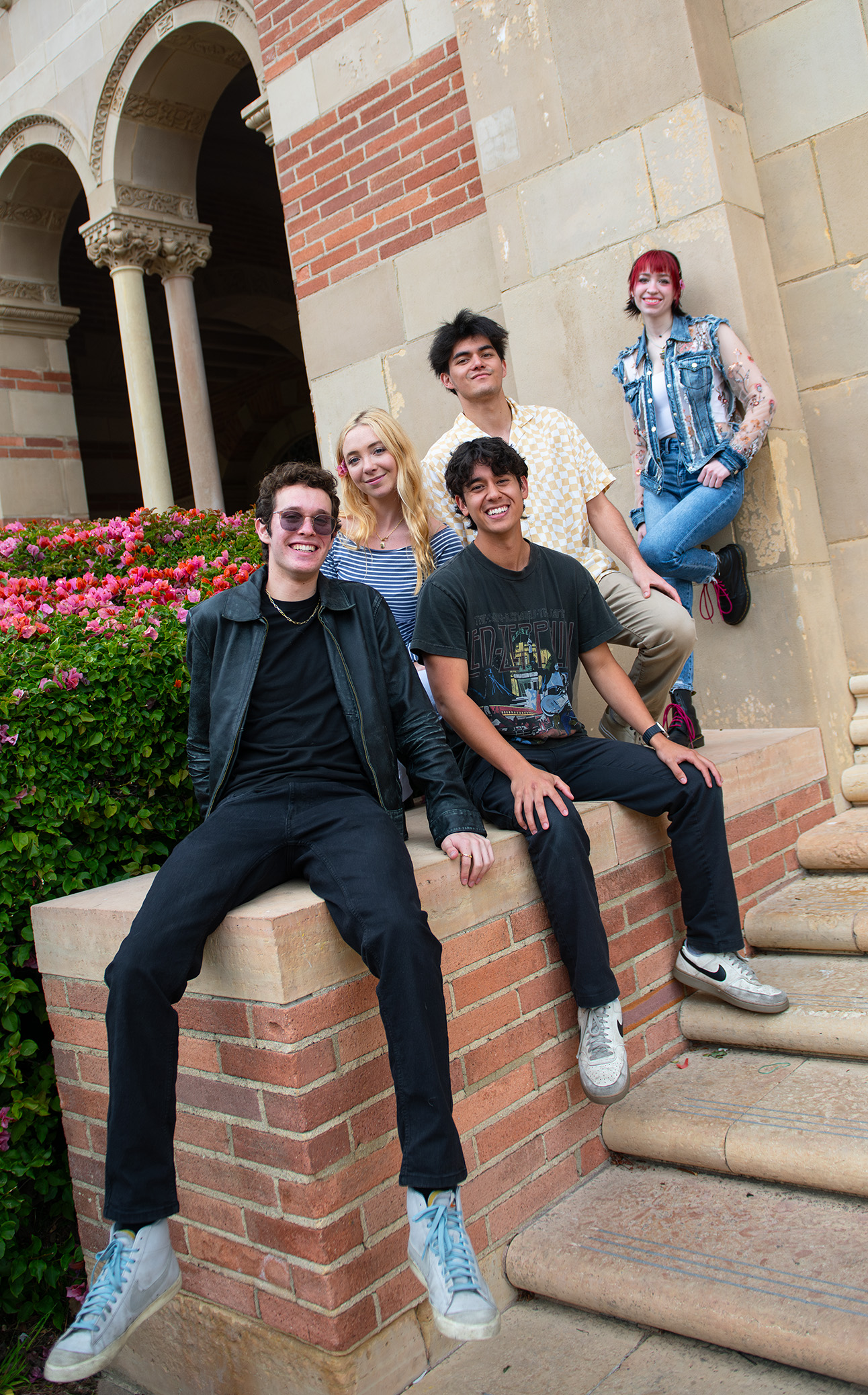 Matty Gottesman (left) and his bandmates look toward the camera while outside Royce Hall. The student singer-songwriter has performed at venues such as The Bourbon Room and The Mint. (Isabella Appell/Daily Bruin)