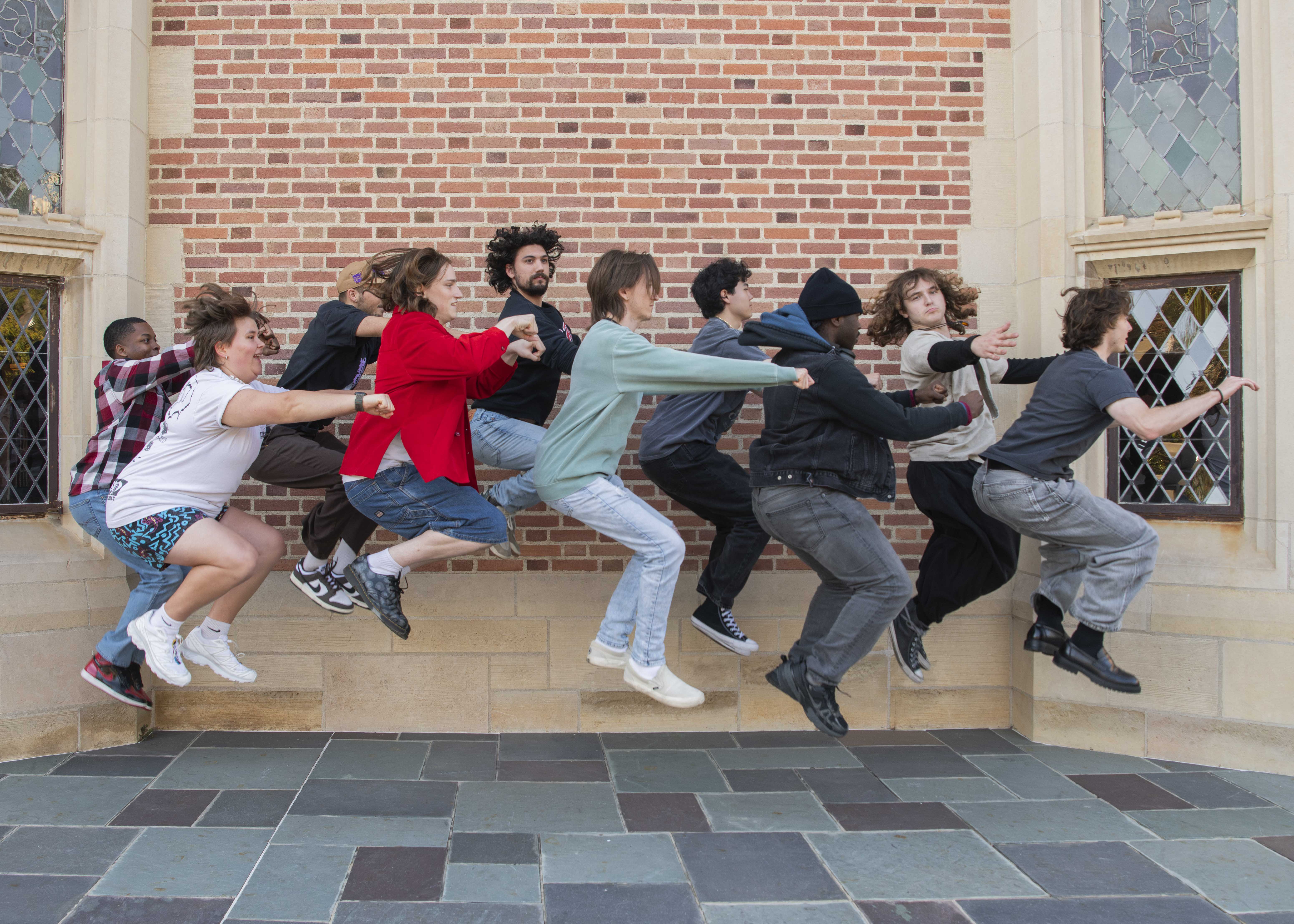 Members of The Band Called Sex pose for a photo on Kerckhoff Patio by jumping simultaneously while in front of a brick wall. The group will perform their track "Mirage Melting" off their forthcoming album at Spring Sing. (Ruby Galbraith/Daily Bruin)