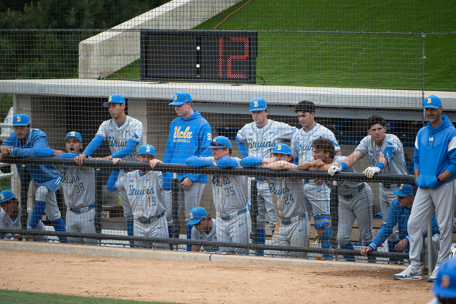 Members of UCLA baseball watch from the dugout at Great Park. (Jeannie Kim/Daily Bruin senior staff)