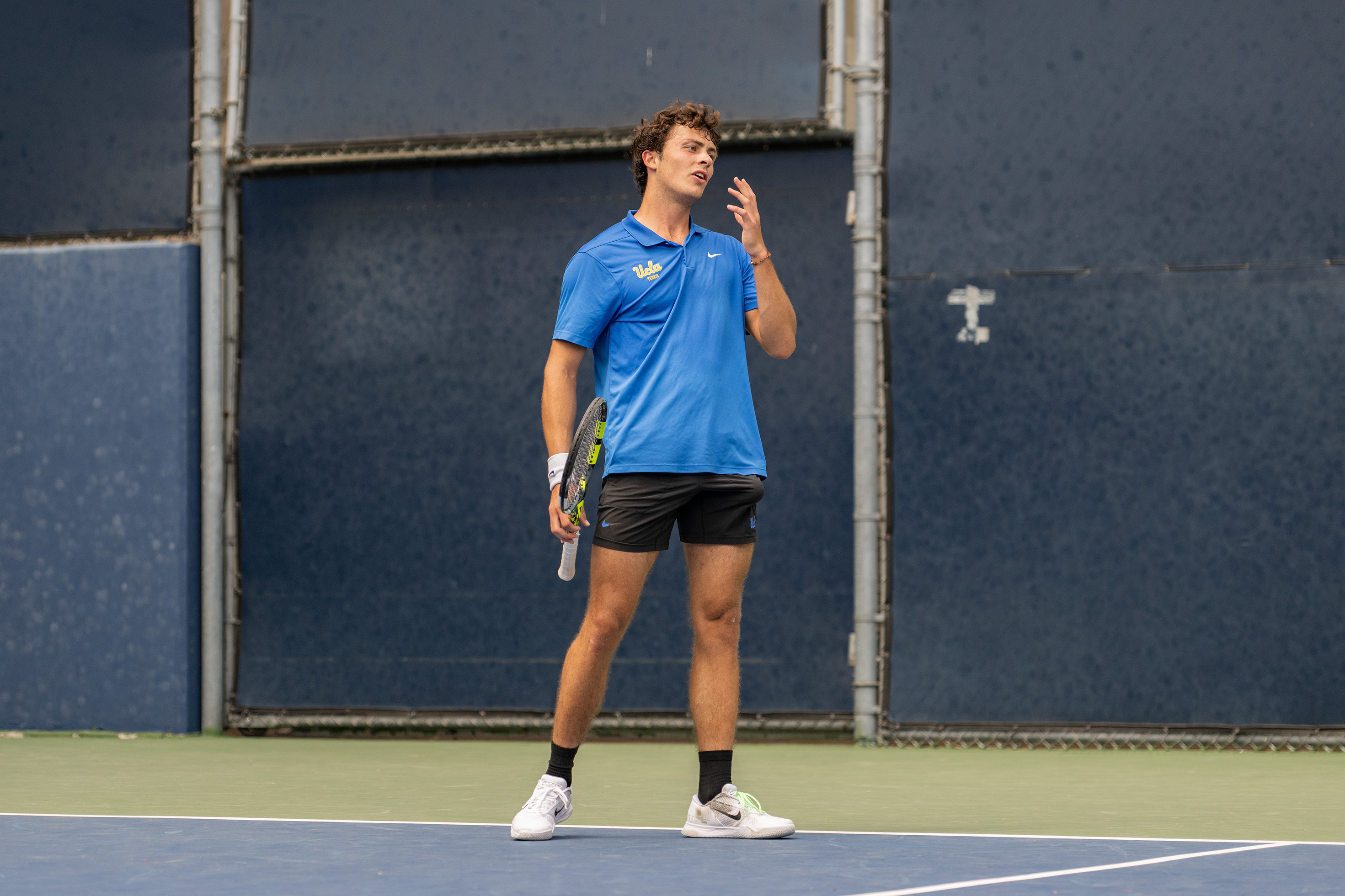 Senior Giacomo Revelli stands on the baseline of court six. (Brianna Carlson/Daily Bruin staff)