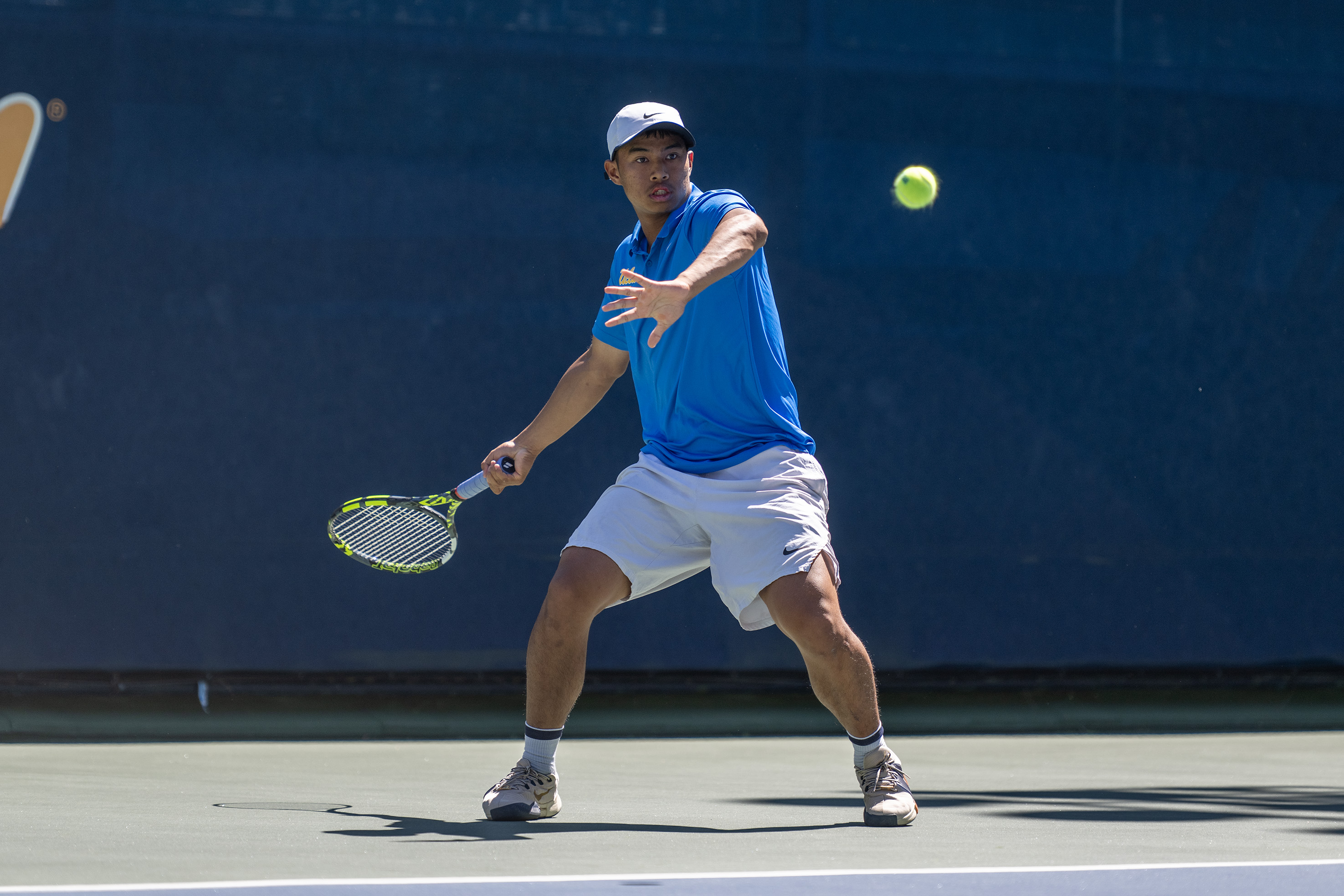 No. 20 freshman Rudy Quan prepares to return a ball on court one. (Brianna Carlson/Daily Bruin staff)