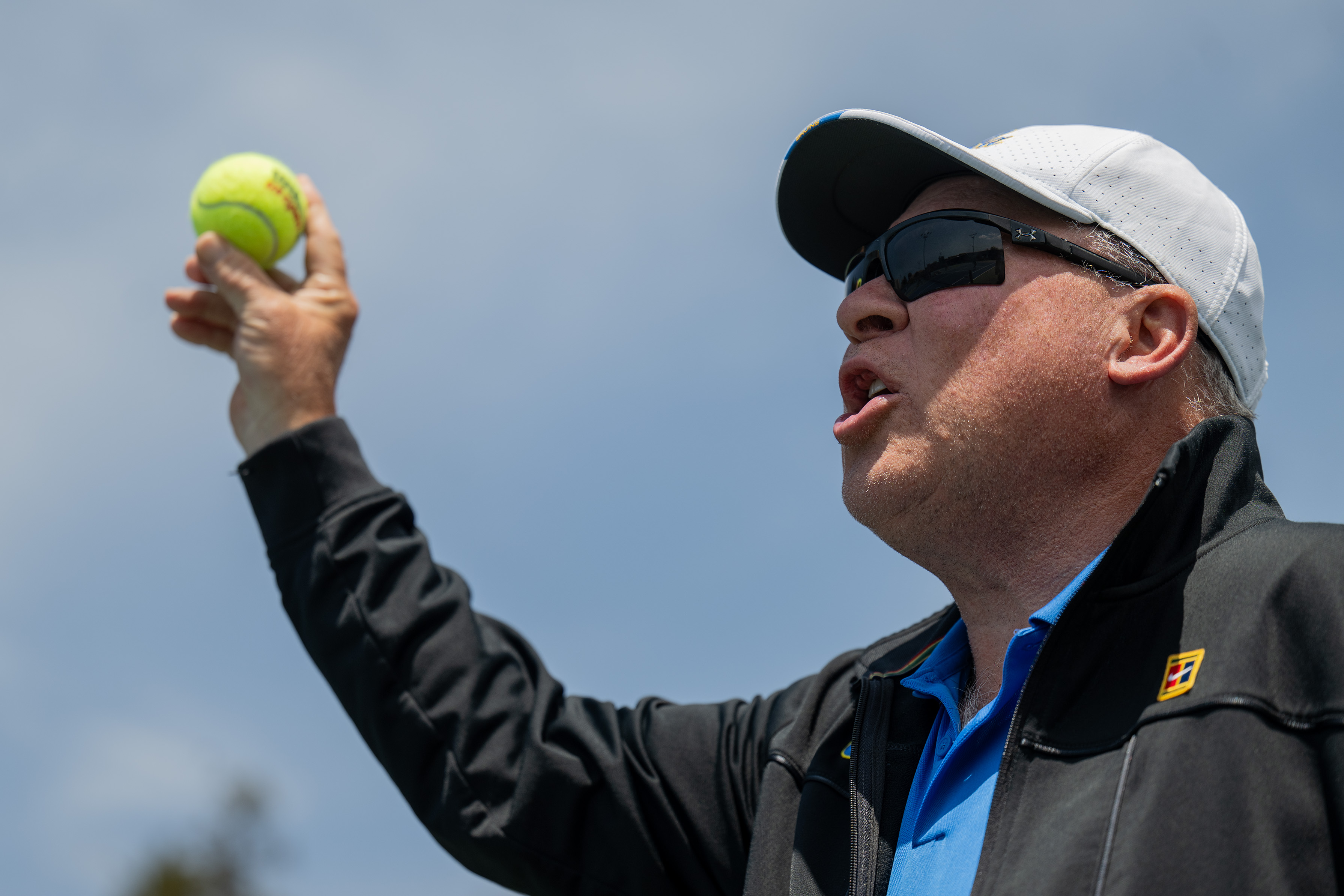 Coach Billy Martin holds a tennis ball in his right hand. (Nicolas Greamo/Daily Bruin senior staff)