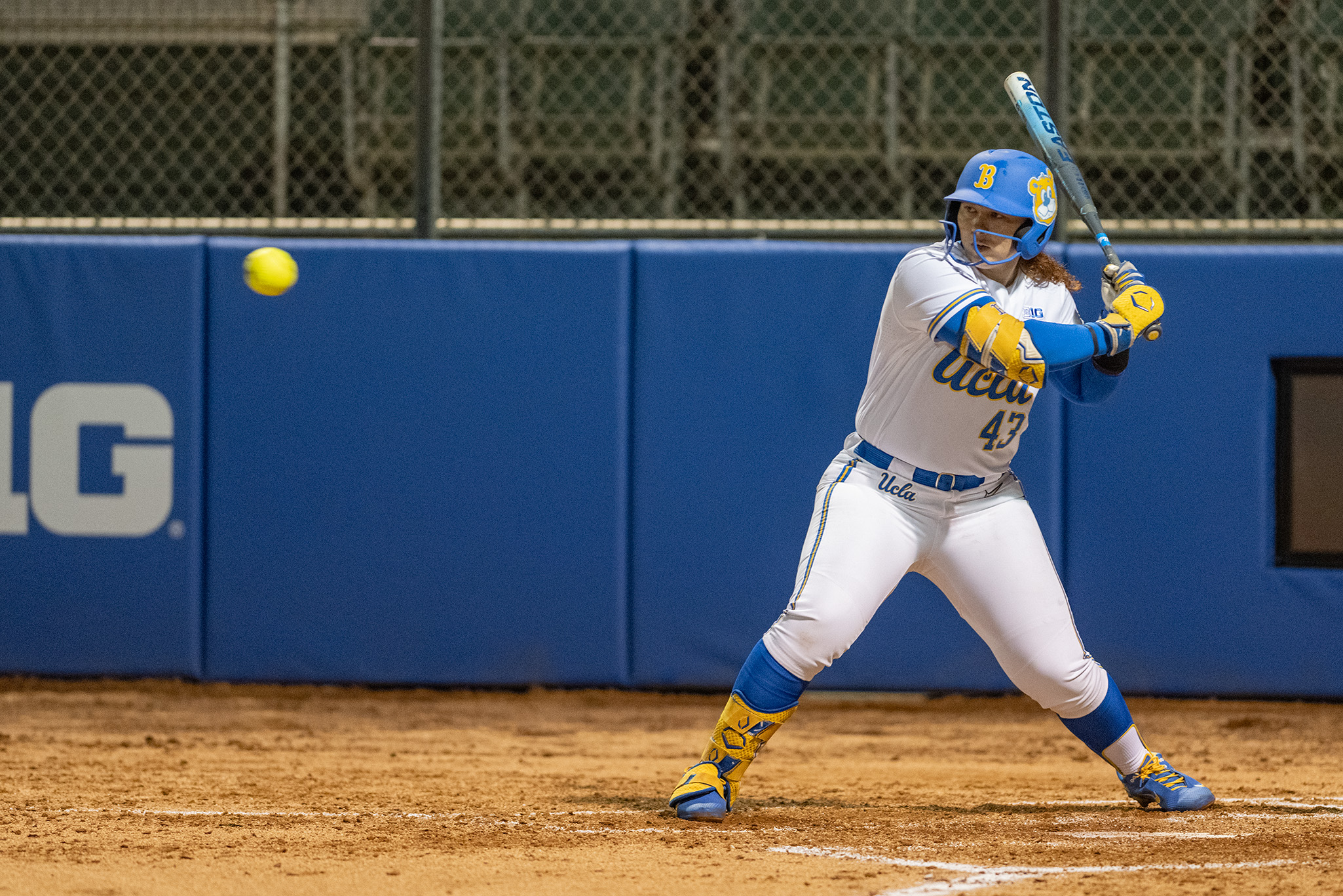 Junior utility Megan Grant readies to swing at the incoming pitch from the left-handed batter's box at Easton Stadium. (Isabella Appell/Daily Bruin)