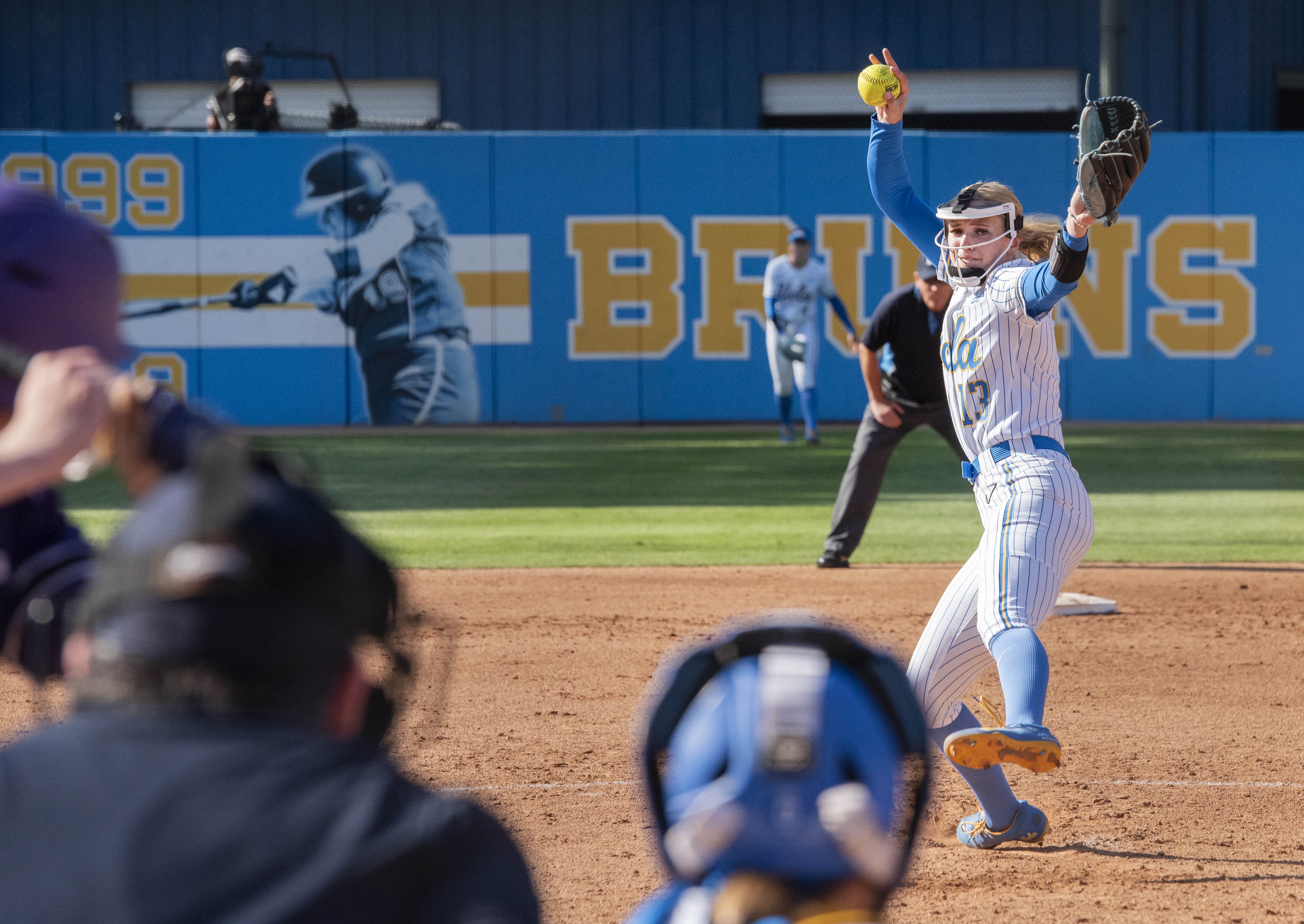 Freshman pitcher/utility Addisen Fisher reaches back and prepares to deliver a pitch to the batter. (Bettina Wu/Daily Bruin senior staff)