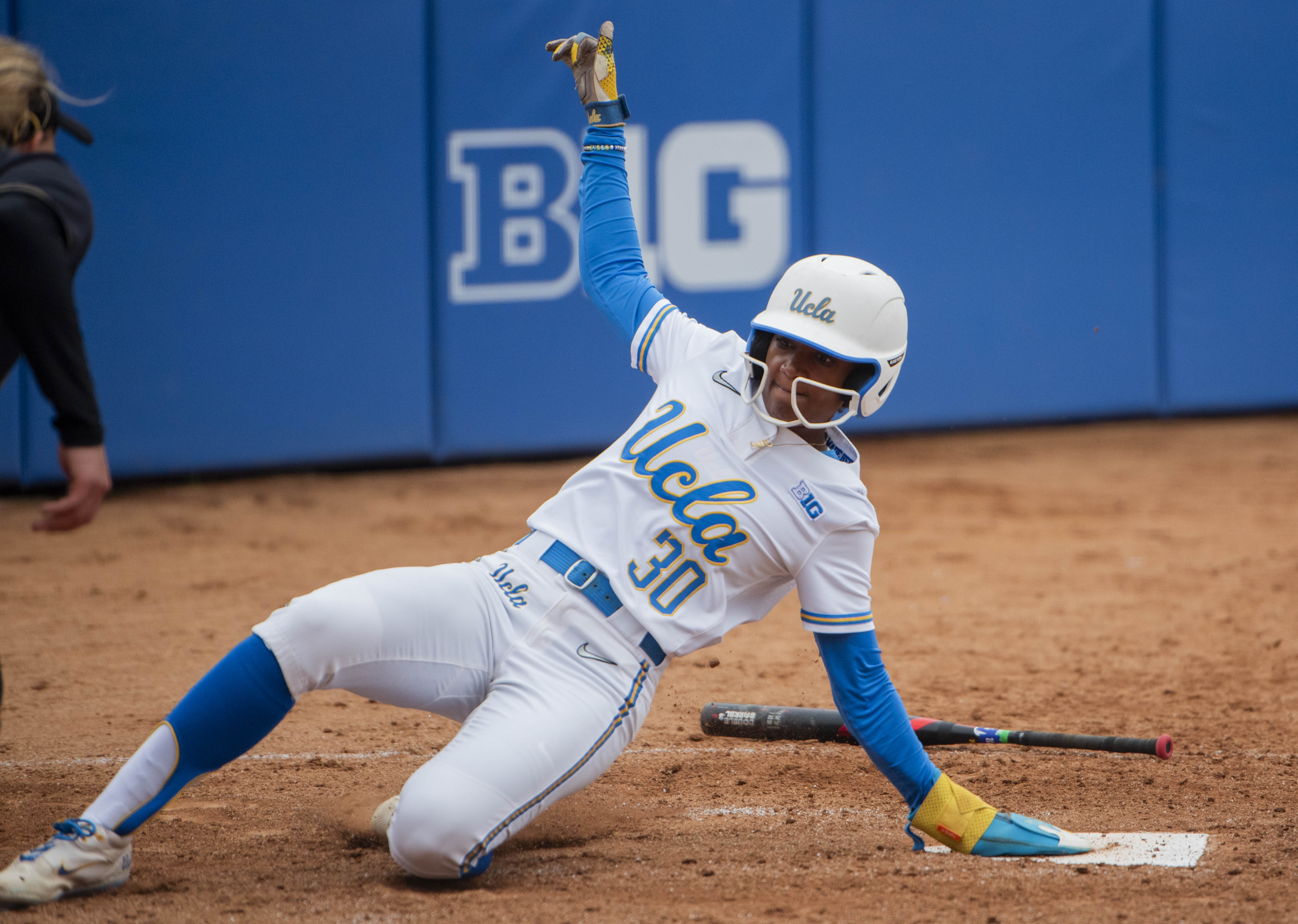 Senior outfielder Lauren Hatch slides into home plate. Hatch was one of eight players celebrated on Senior Day. (Karla Cardenas-Felipe/Daily Bruin staff)