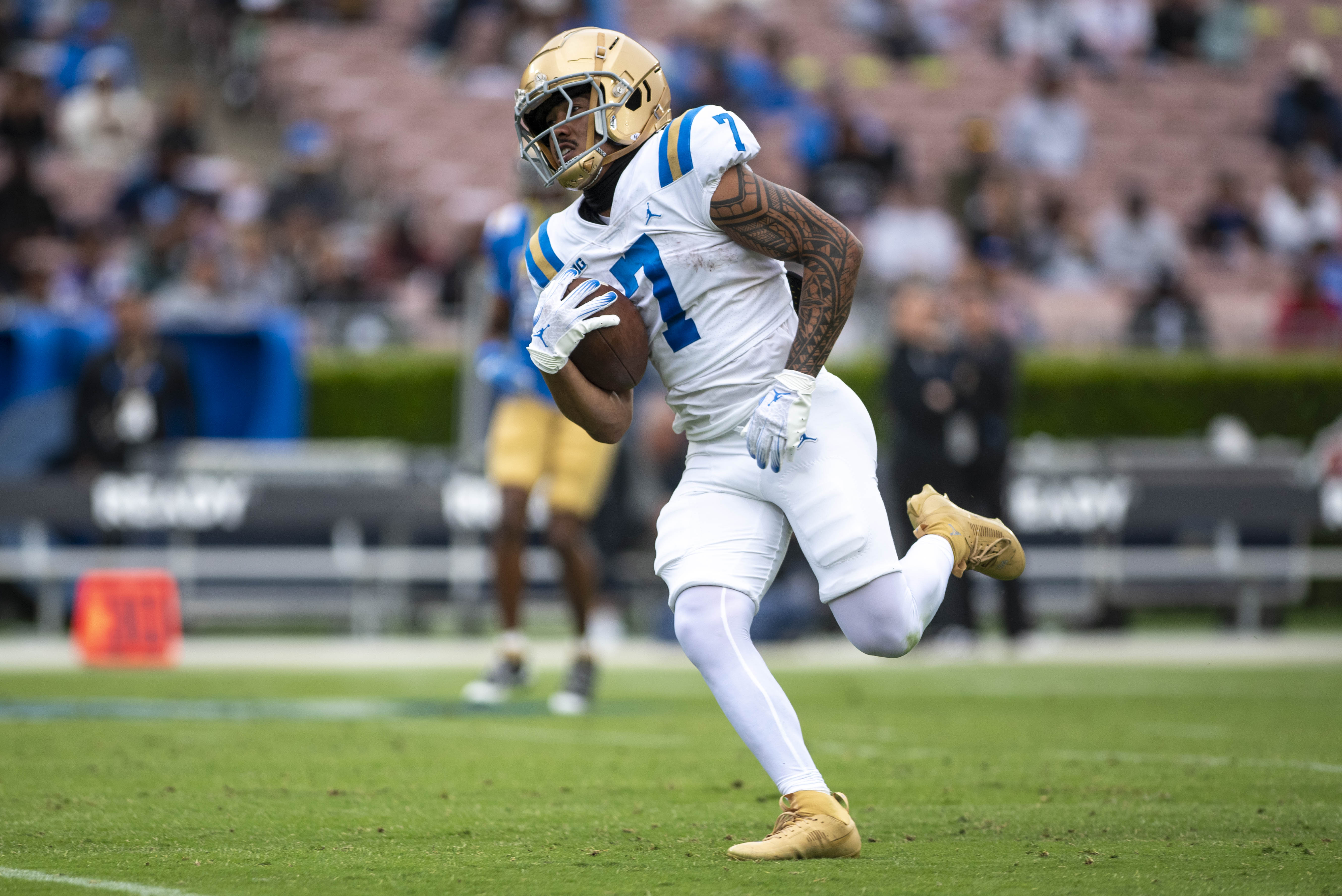 Sophomore wide receiver Mikey Matthews carries the ball toward the end zone. (Max Zhang/Daily Bruin)