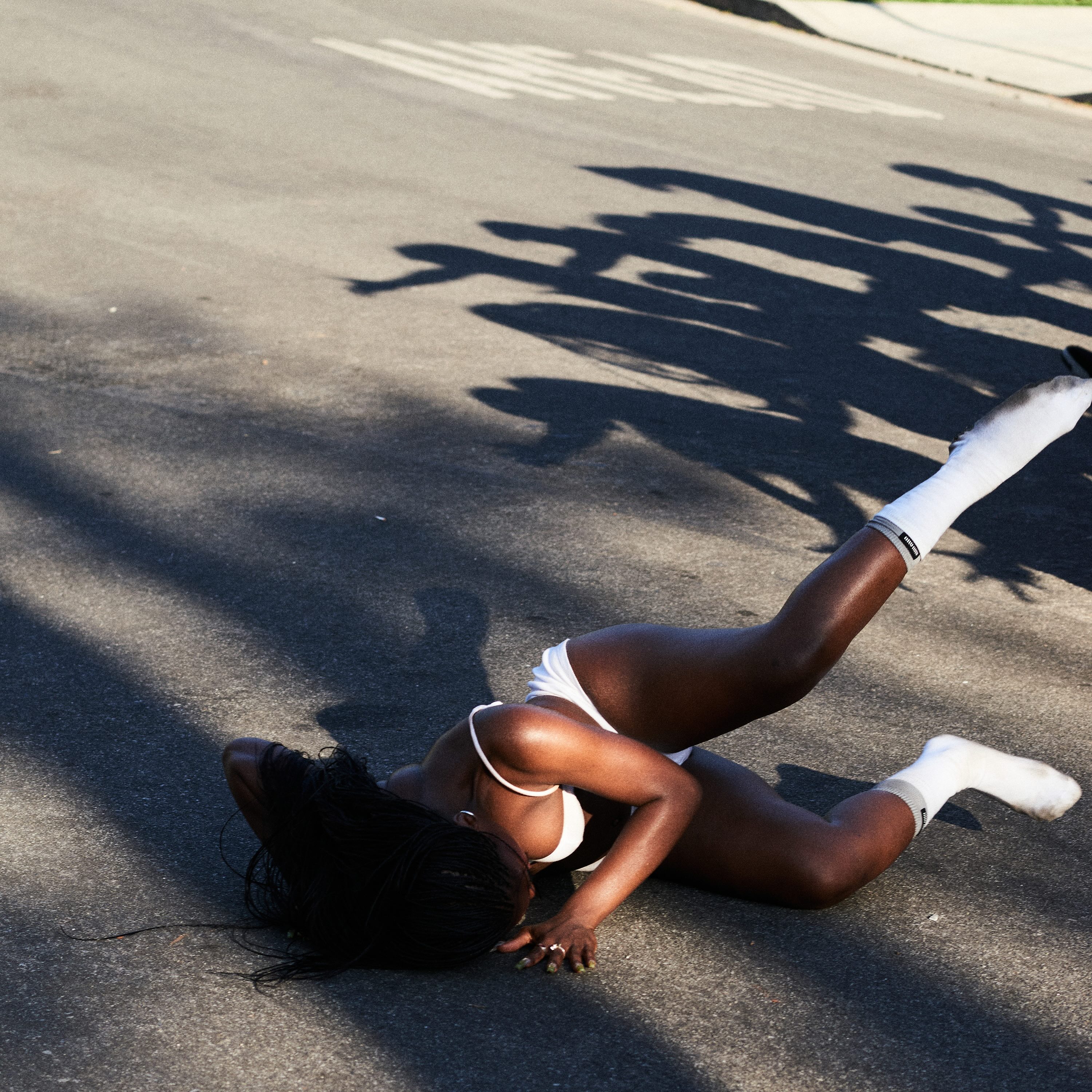 Doechii falls on the street and breaks her fall with her hands while wearing all-white on the cover of her single "Anxiety." The hit single&squot;s music video was released on Apr. 18 and features unpredictable situations reflecting the fearful emotions portrayed through the song. (Courtesy of Top Dawg Entertainment, LLC, under exclusive license to UMG Recordings, Inc. and Capitol Records)