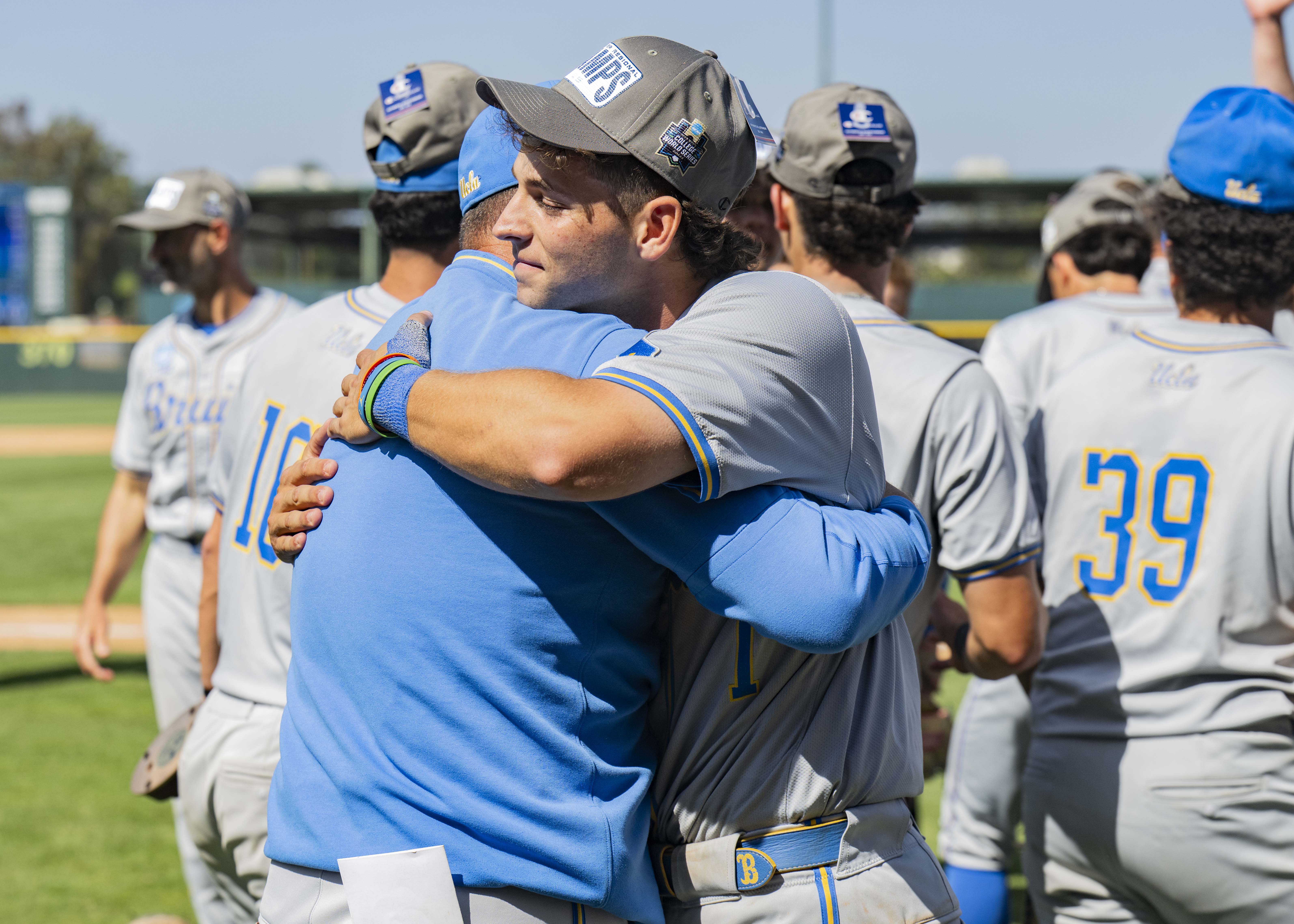 Sophomore shortstop Roch Cholowsky (right) embraces Savage (left). (Aidan Sun/Assistant Photo editor)