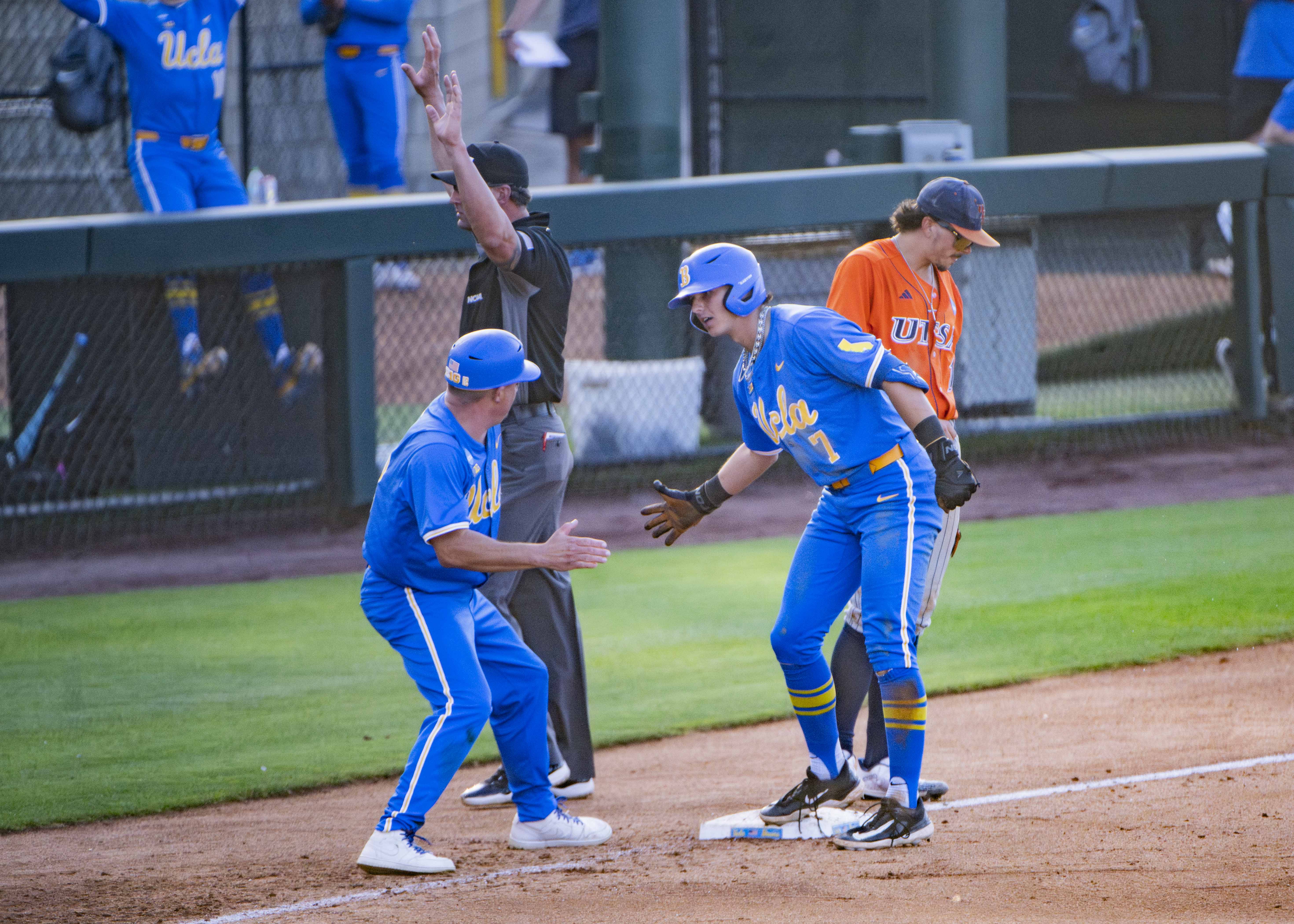 Sophomore third baseman Roman Martin and third base coach Niko Gallego celebrate at third base. (Michael Gallagher/Assistant Photo editor)