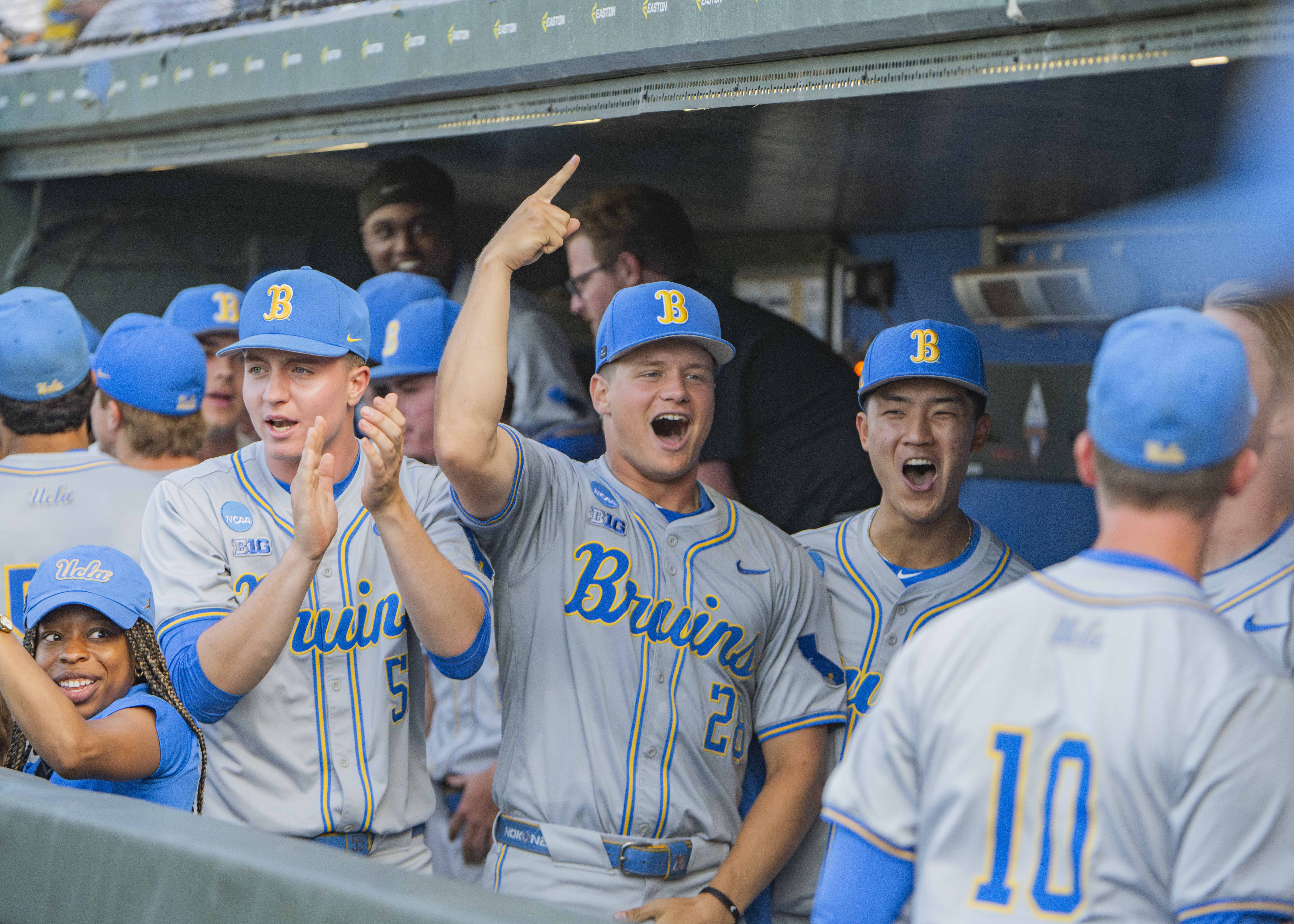 Right-handers sophomore Justin Lee (right), sophomore Cal Randall (center) and junior Michael Barnett (left) celebrate in the bruin dugout. (Brianna Carlson/Daily Bruin staff)