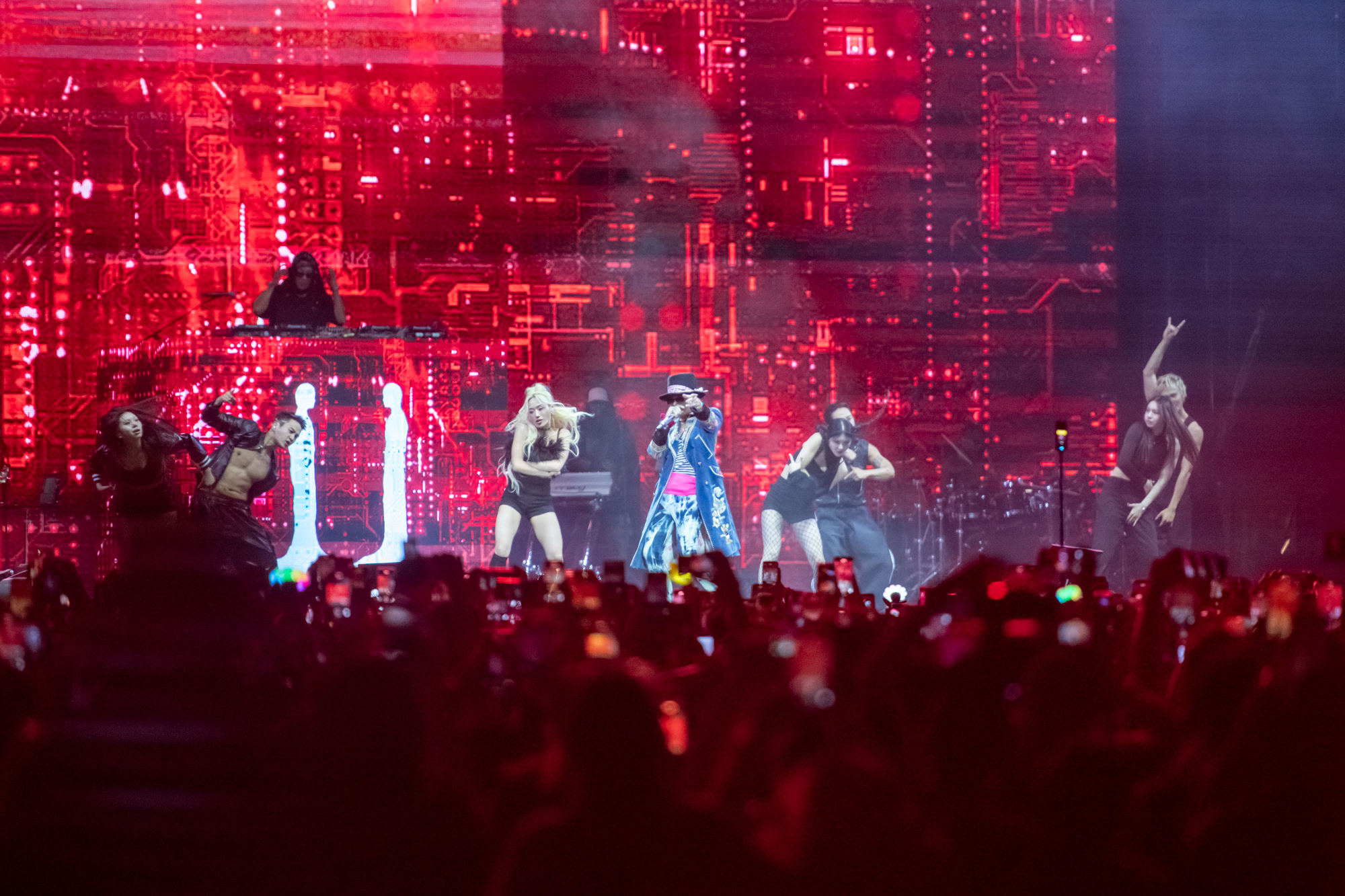 G-DRAGON performs on stage amid red lights at the first day of the Head in the Clouds Music & Arts Festival on Saturday in Pasadena, California. The artist&squot;s set featured a guest appearance by CL and the performances of multiple tracks from his latest album "Übermensch." (Max Zhang/Daily Bruin)