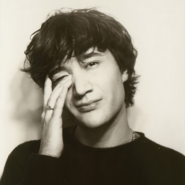 A monochrome photo of beaux with his hand raised over his eye. The English singer-songwriter independently released his debut album on June 3. (Courtesy of Phzle Records and beaux)