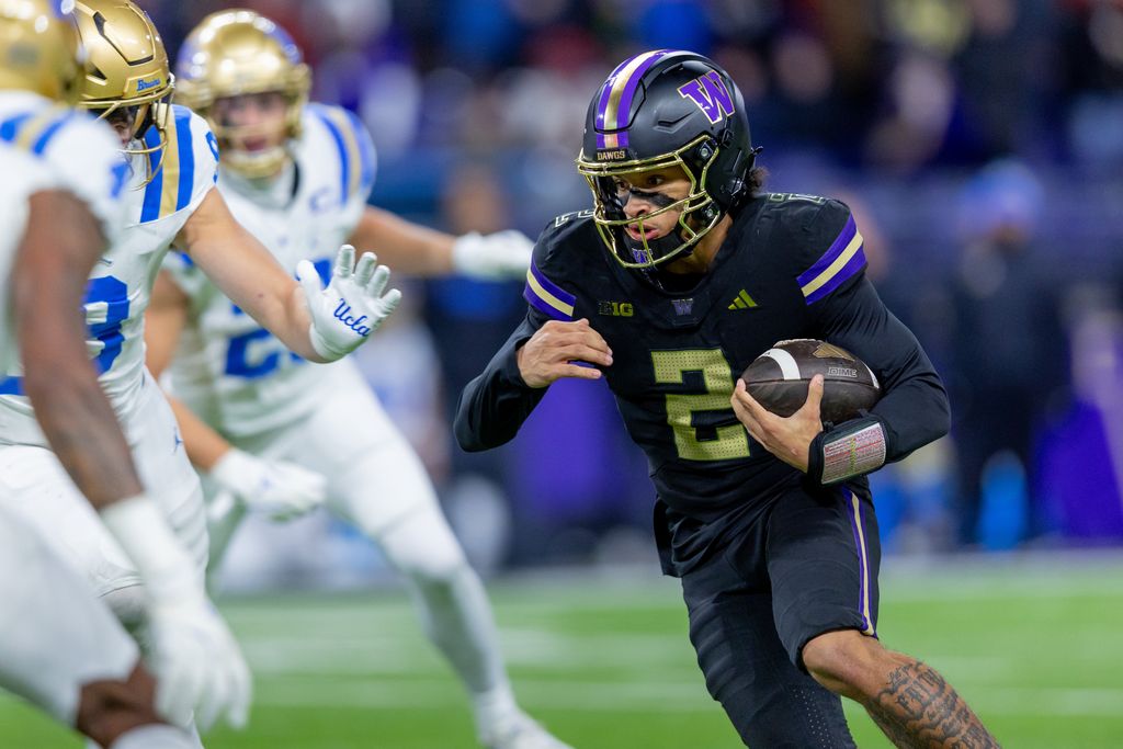Quarterback Desmond Williams Jr. scrambles out of the pocket and prepares to take a hit from a defender. The four-star recruit threw eight passing touchdowns compared to just one interception on a 78.1% completion percentage during his debut season with the Huskies.