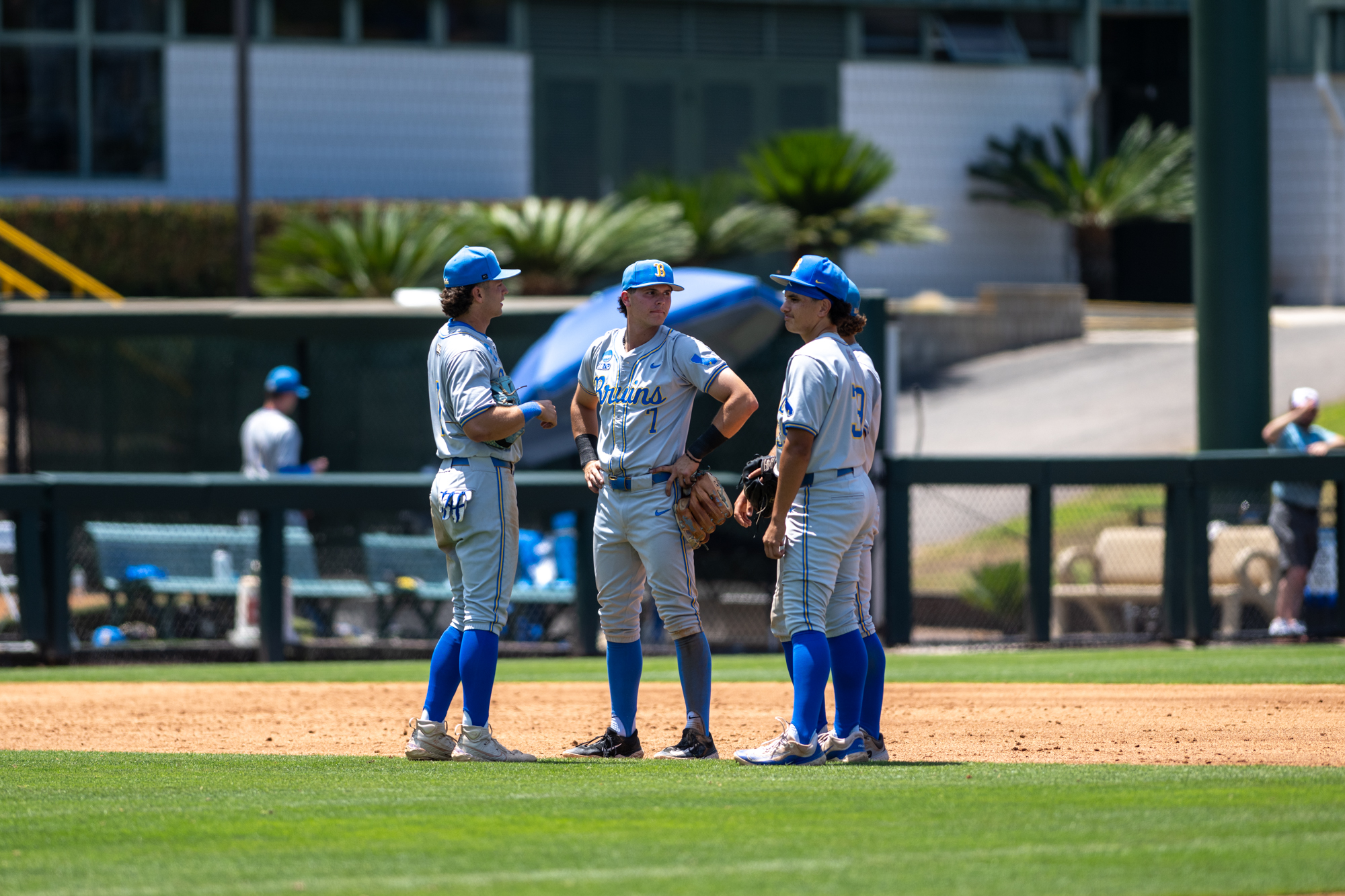 UCLA baseball infield stands in a circle talking. The infield led the NCAA in double plays with 66 on the year. (Aidan Sun/Assistant Photo editor)