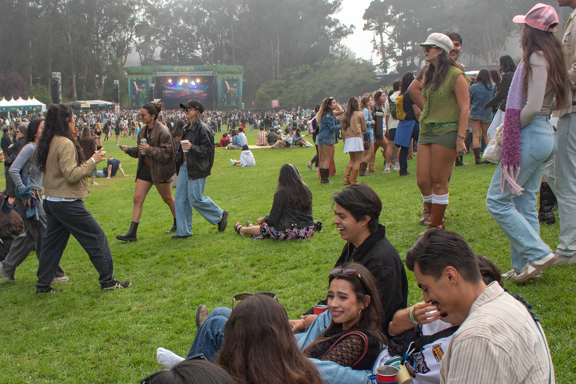 Outside Lands' crowd walking and sitting down on Golden Gate Park's lawn. Gracie Abram's hour-long set brought a range of crowd reactions, culminating in a quality performance. (Isabella Appell/Daily Bruin)