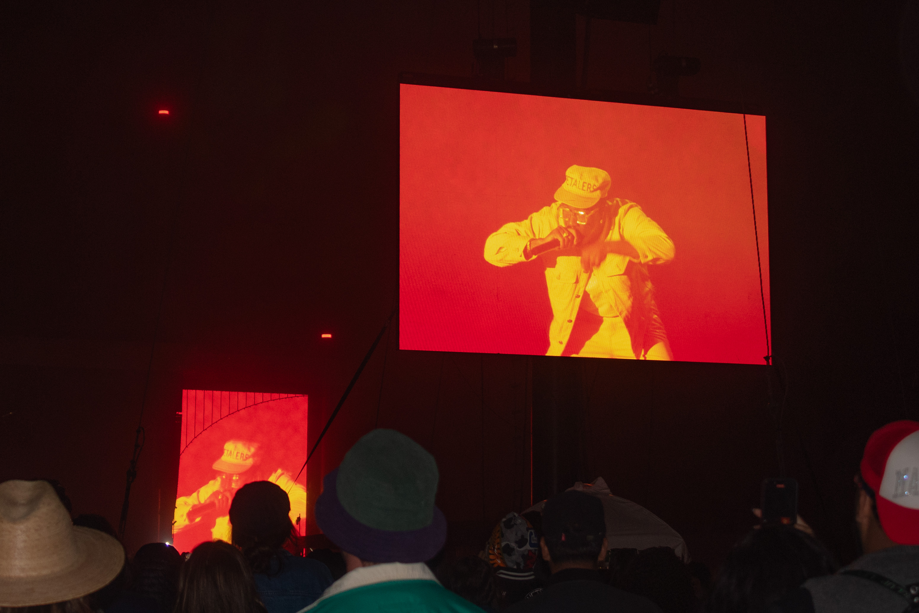 Tyler, The Creator on the Lands End stage screen, wearing an all-yellow outfit. The artist danced to his setlist along with the audience, creating an energetic closing act for day two. (Isabella Appell/Daily Bruin)