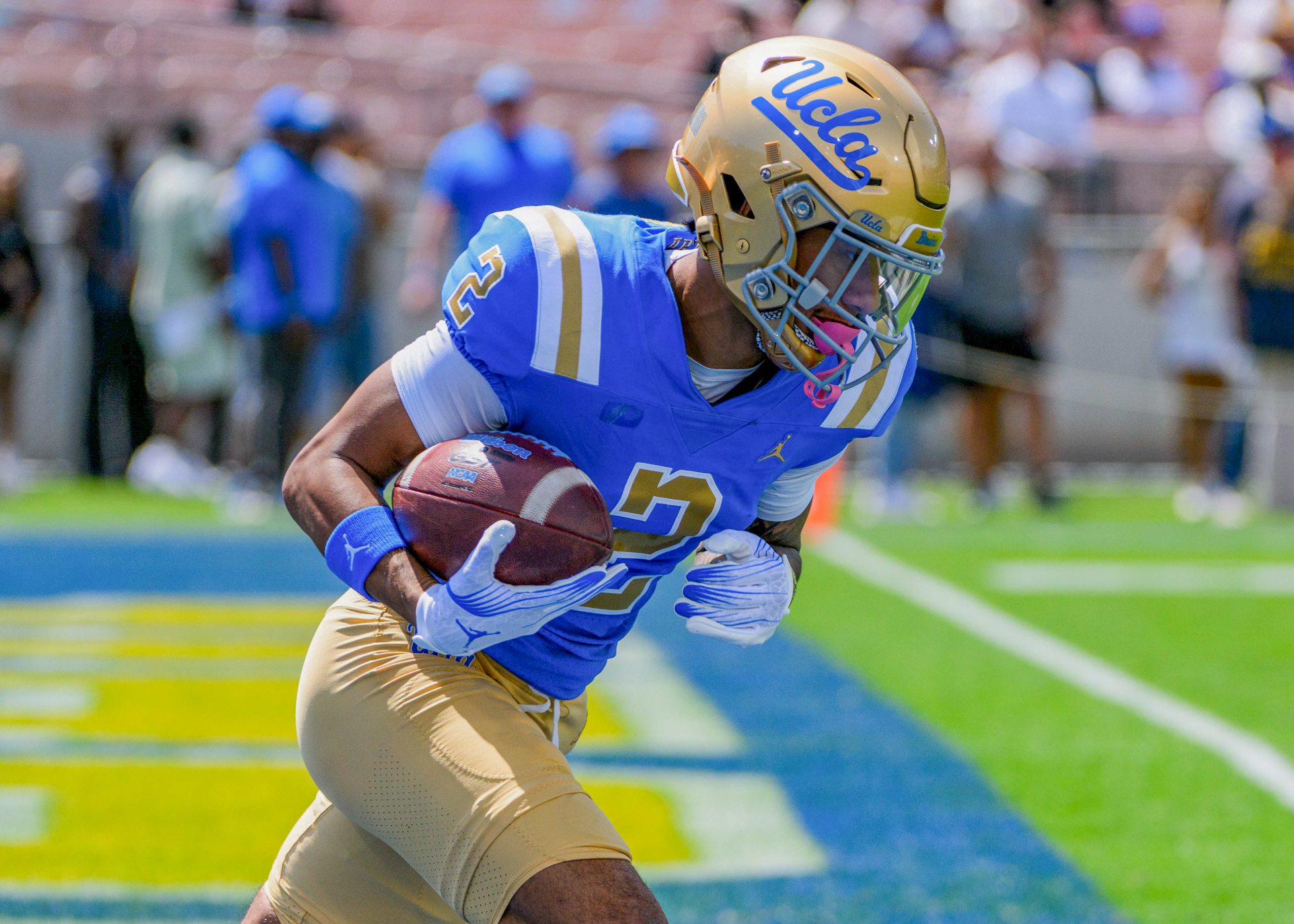 Redshirt senior wide receiver Titus Mokiao-Atimalala runs with the ball tucked under his arm in the end zone of the Rose Bowl. He ended last season with 28 receptions for 294 receiving yards. (Zimo Li/Daily Bruin senior staff)