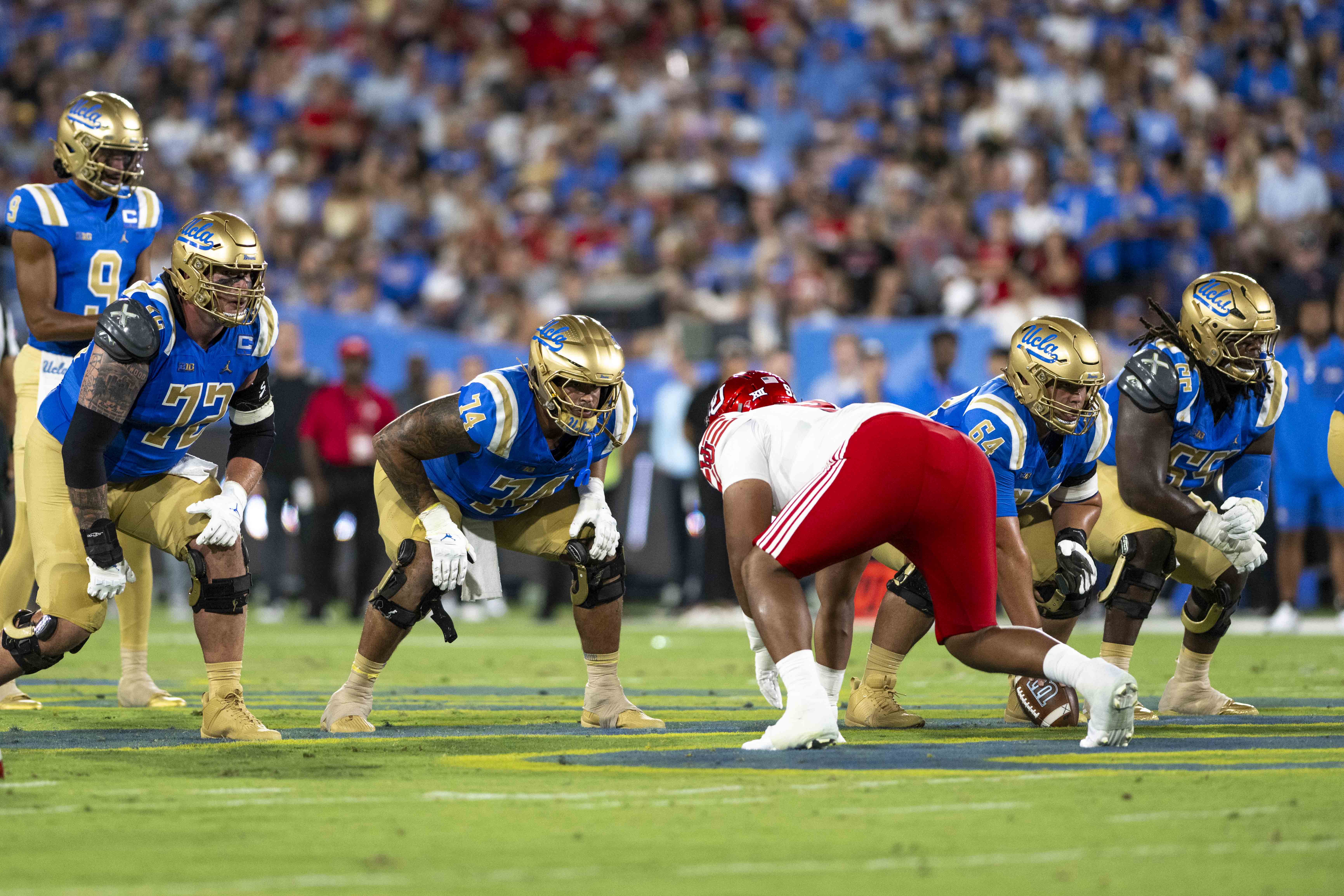 The UCLA offensive line waits in position for redshirt sophomore quarterback Nico Iamaleava to call for the snap.