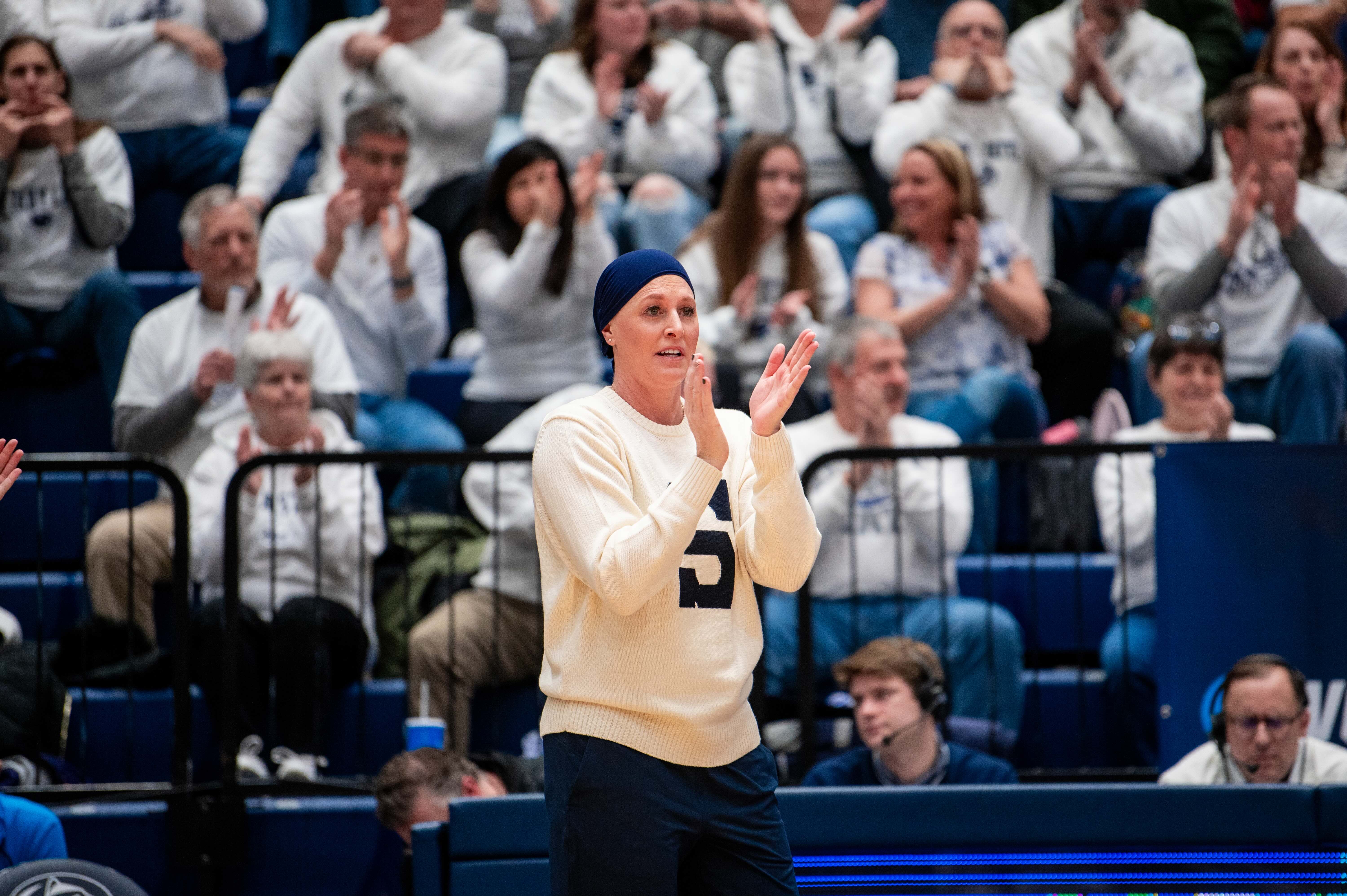 Coach Katie Schumacher-Cawley claps on the sidelines. Schumacher-Cawley became the first woman head coach to win a national championship last season. (Courtesy of Penn State Athletics)