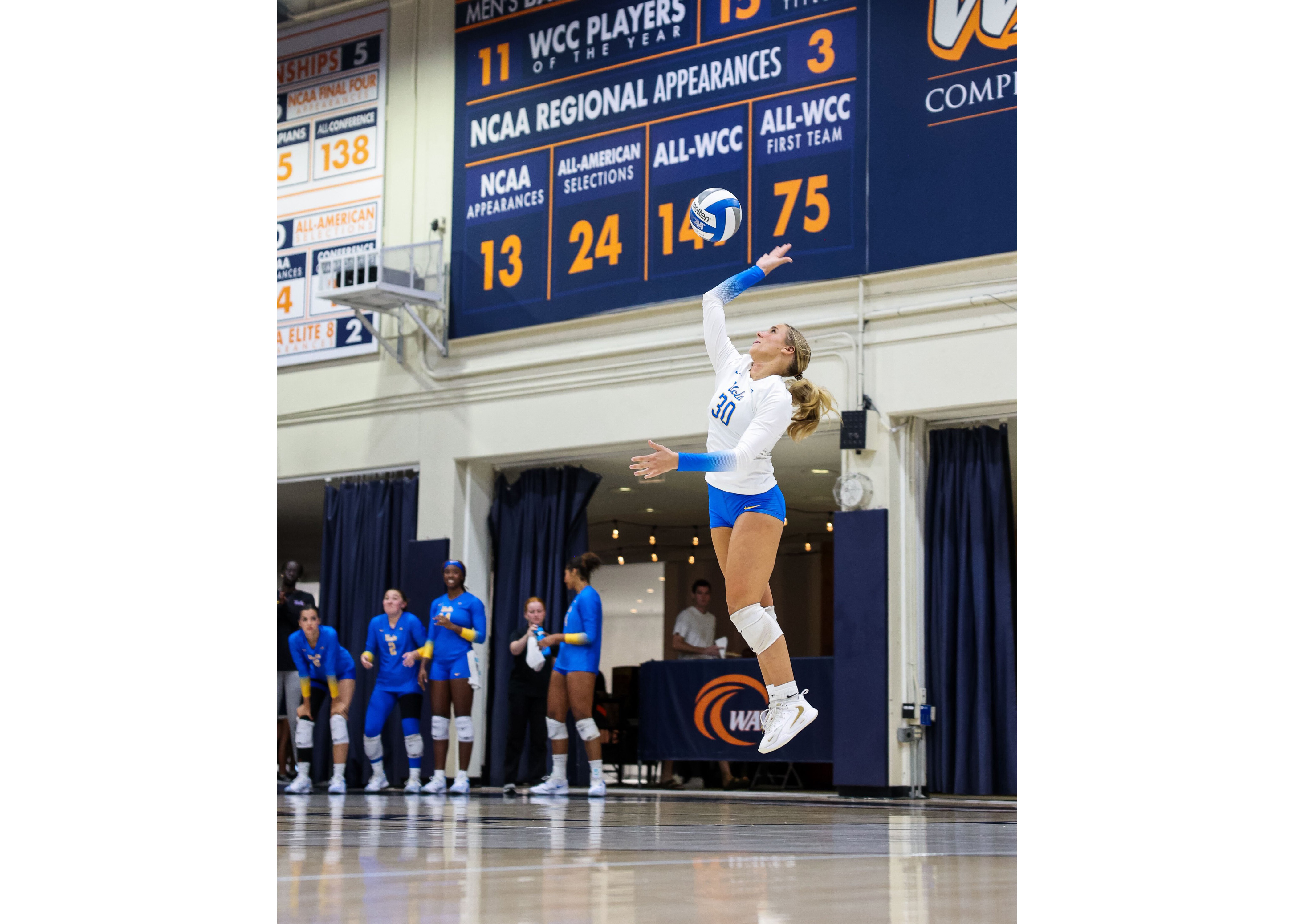 Sophomore libero Lola Schumacher serves the ball. Schumacher had four 20-plus dig matches last season with the Badgers. (Courtesy of UCLA Athletics)