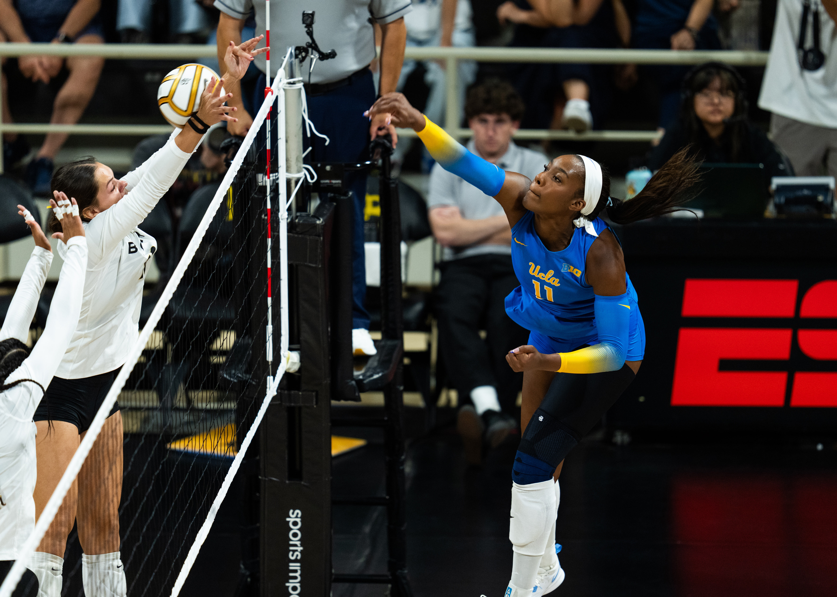 Redshirt junior middle blocker Marianna Singletary hits through the opposing team's block. Singletary recorded a career-high 189 kills last season with the Longhorns. (Courtesy of UCLA Athletics)