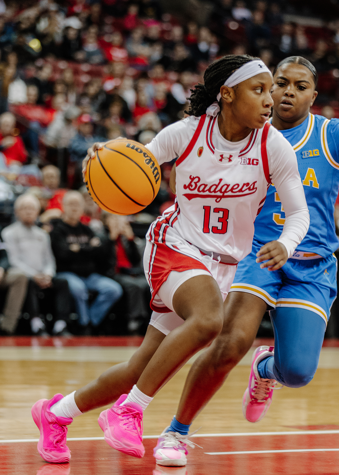Guard Ronnie Porter dribbles the ball with a UCLA defender on her back. (Courtesy of Wisconsin Athletics)