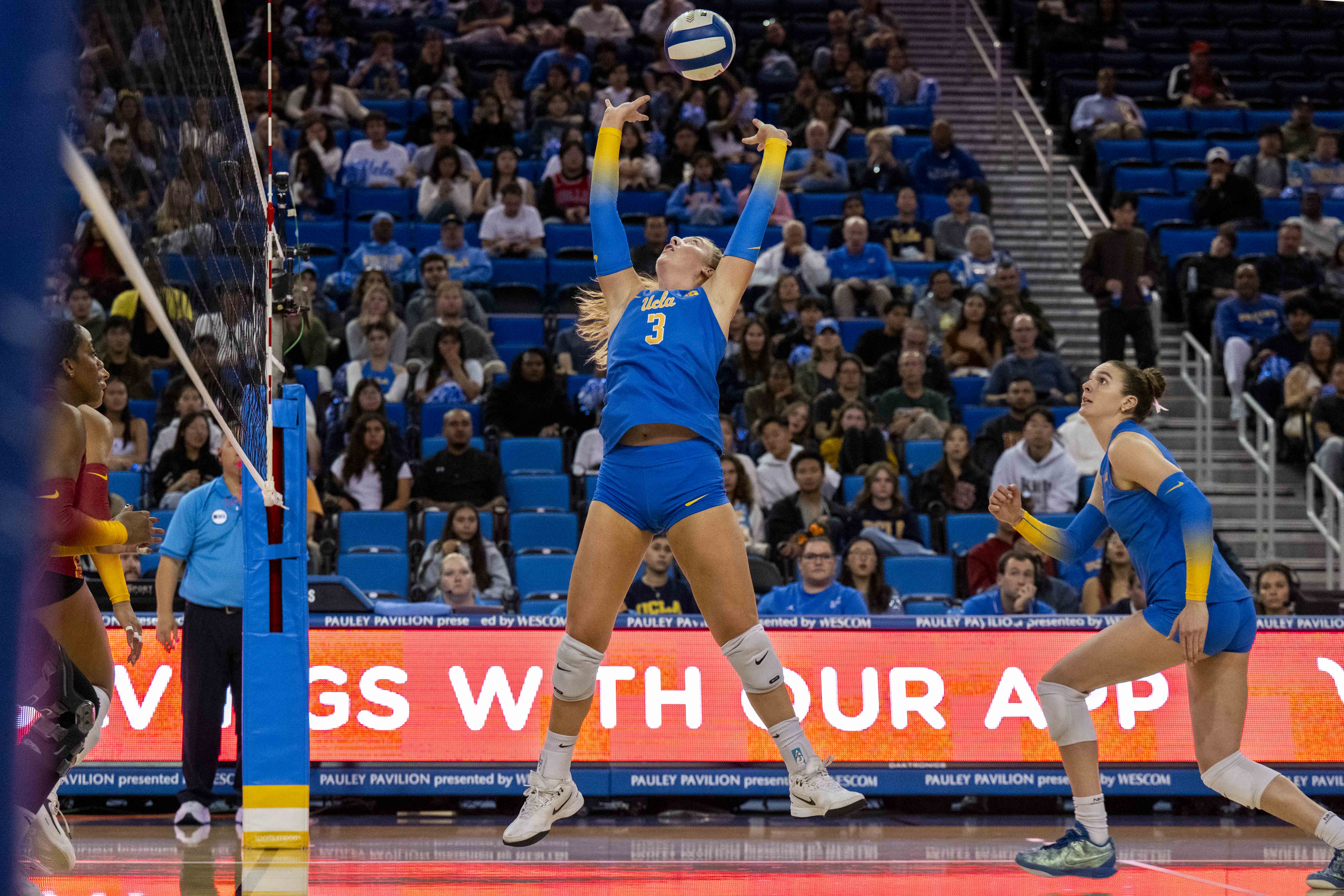 Sophomore setter Kate Duffey jump sets the ball behind her. Duffey combined for 100 assists over the first weekend of Big Ten play. (Nicolas Greamo/Daily Bruin senior staff)