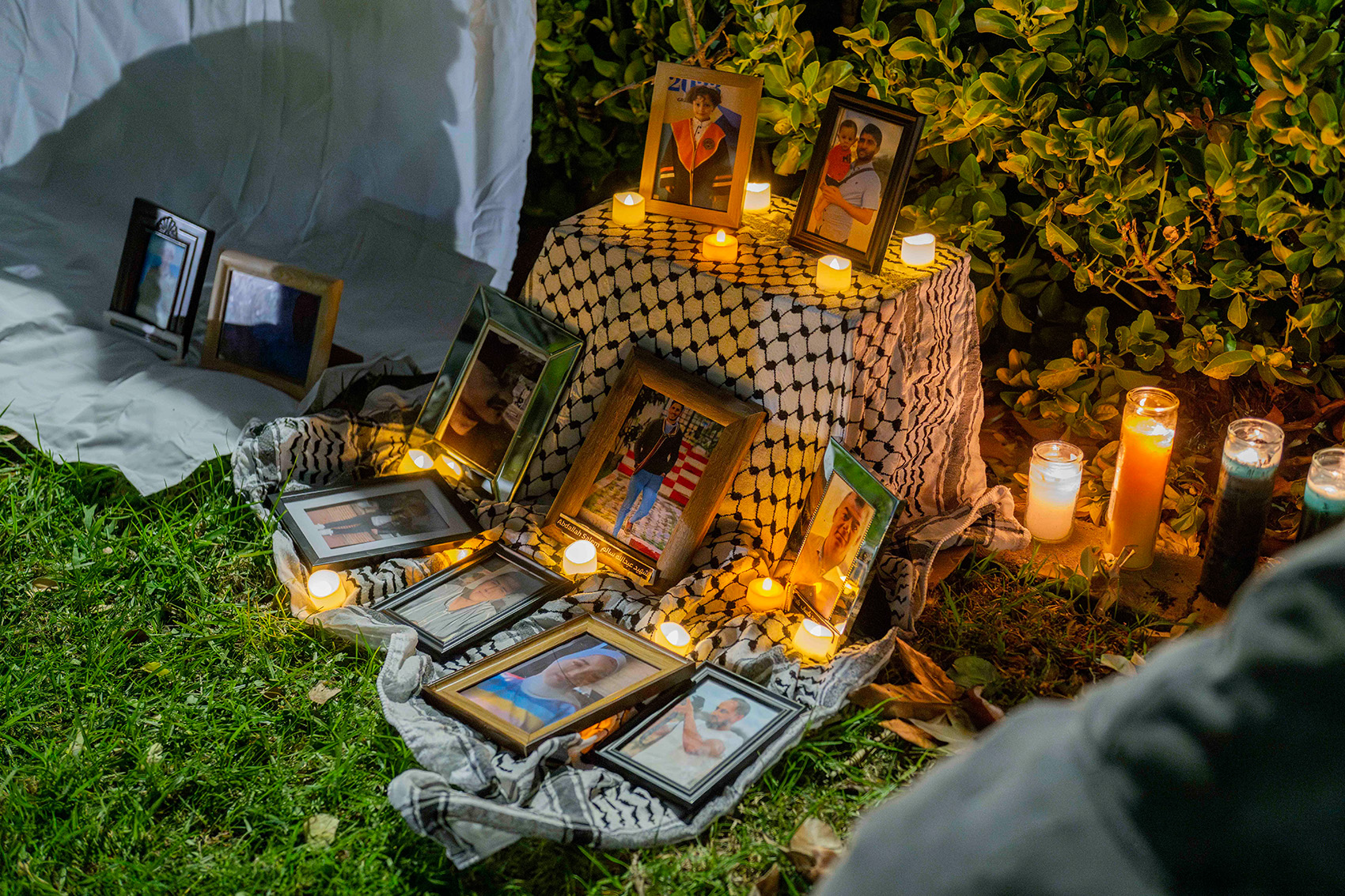 Pictures are displayed at a vigil held Monday for Palestinians killed in the Israel-Hamas war. (Andrew Ramiro Diaz/Photo editor)