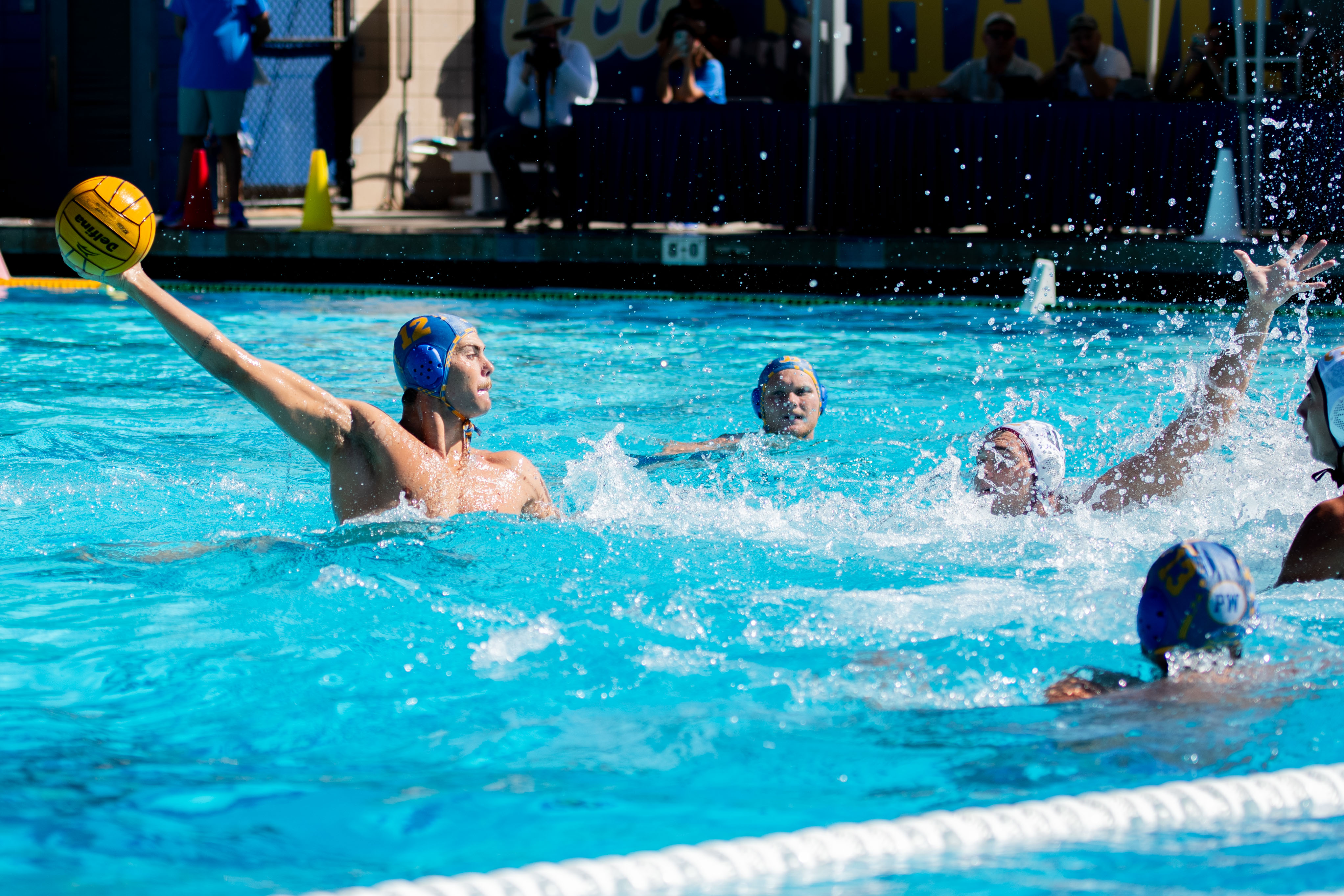 Sophomore utility Bode Brinkema stretches his arm out behind him while holding the ball. (Brianna Carlson/Daily Bruin staff)