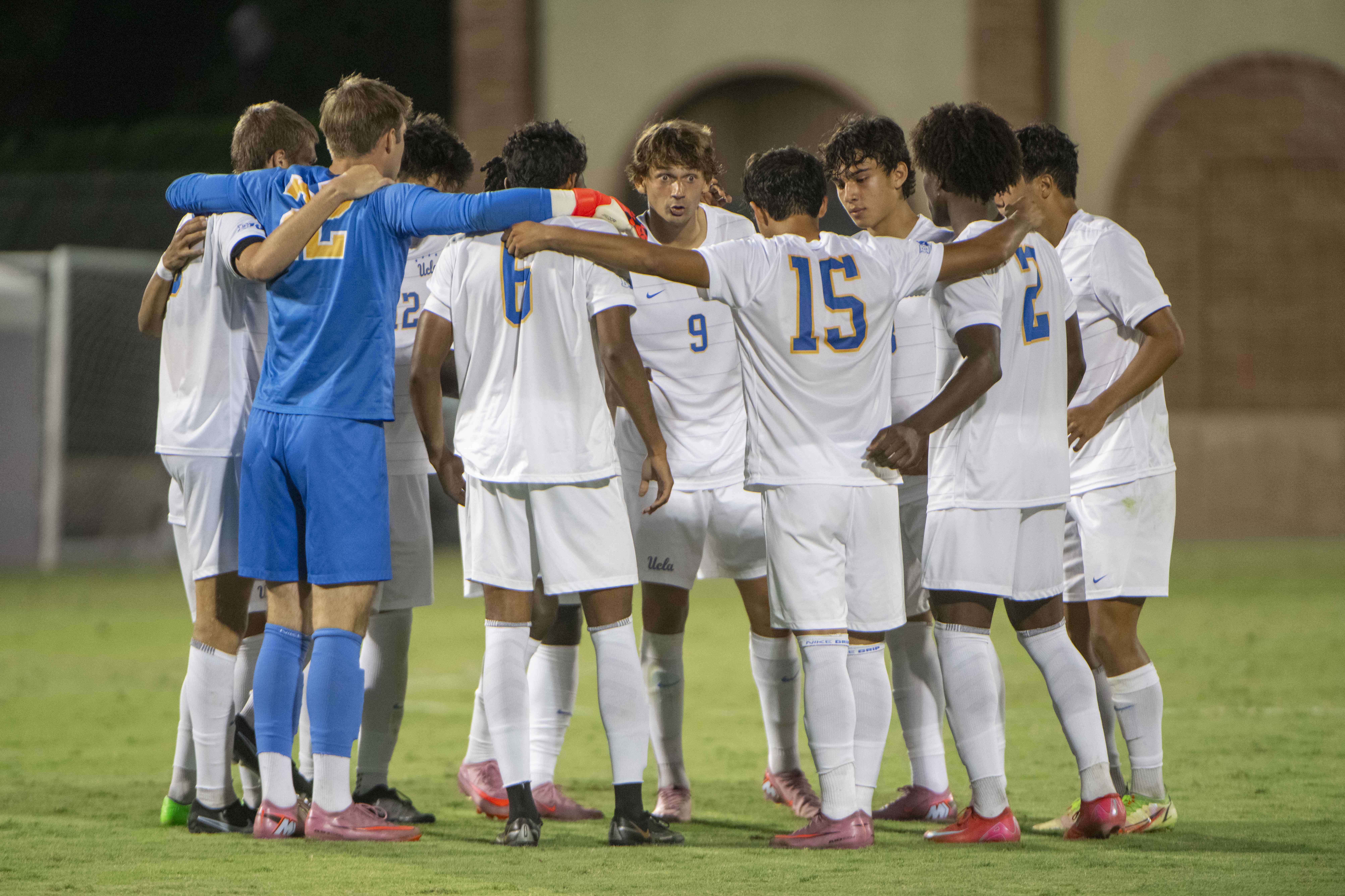 UCLA men's soccer huddles on the field during a game at Wallis Annenberg Stadium. (Andrew Diaz/Photo editor)