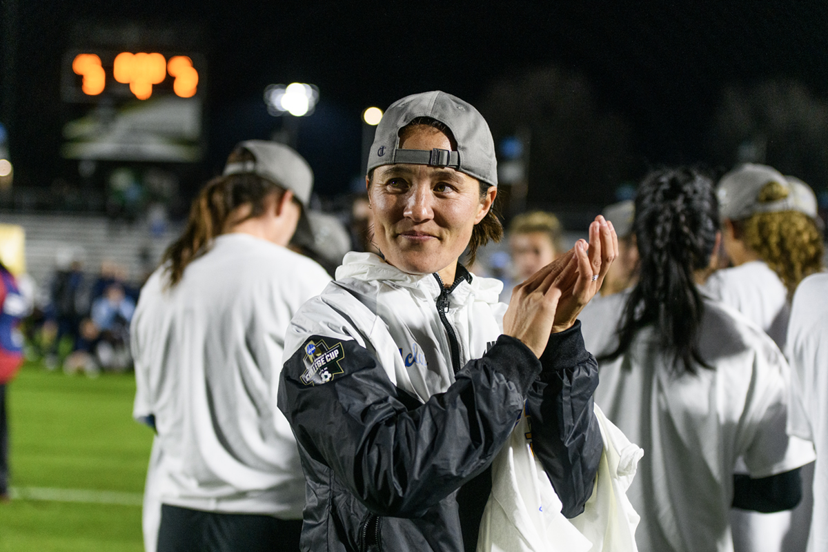 Coach Margueritte Aozasa claps. Aozasa has guided the Bruins to 11 wins this season. (Daily Bruin file photo)