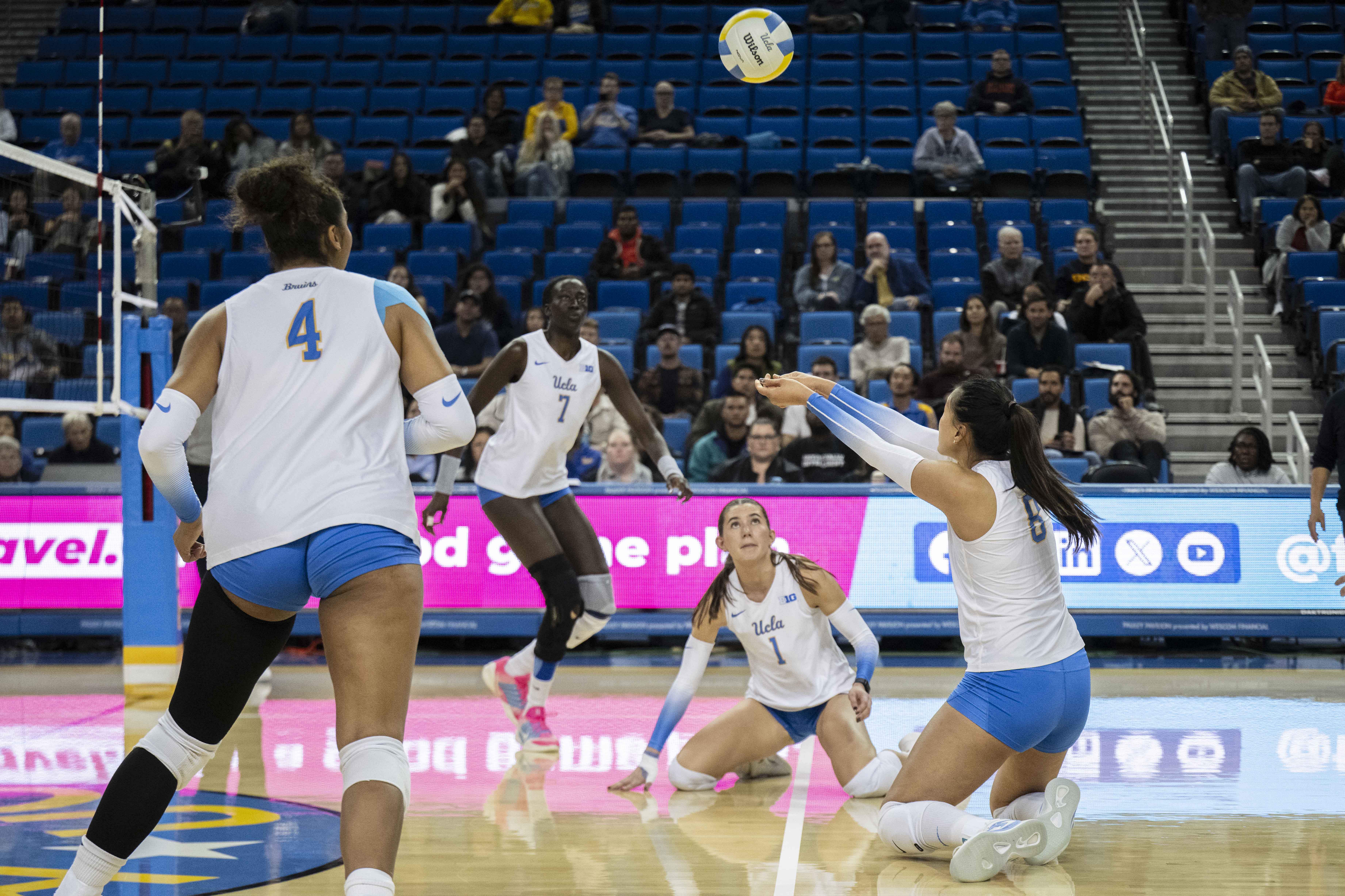 Junior outside hitter Maggie Li dives and passes a ball to her teammates. (Vanessa Man/Daily Bruin)