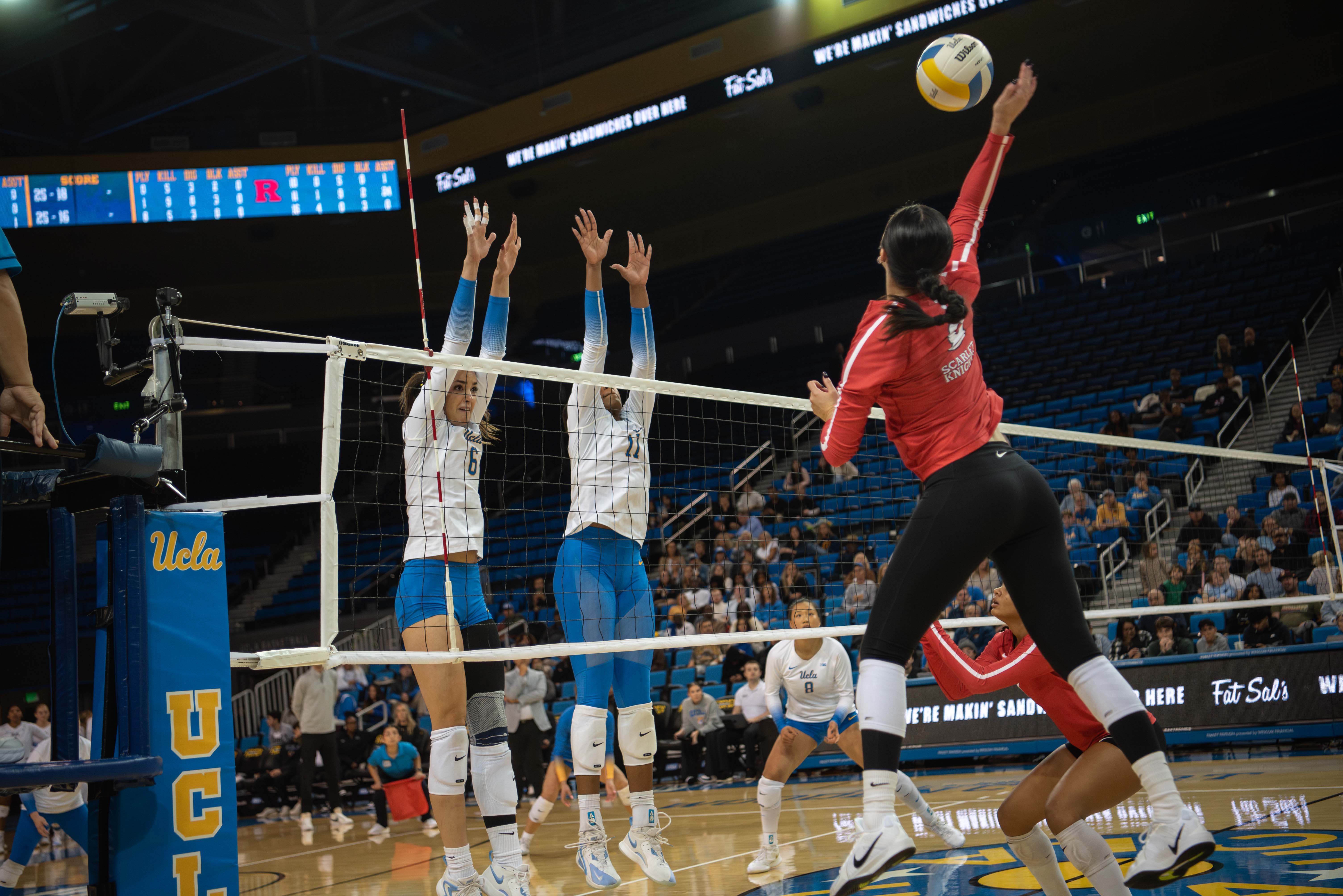 Sophomore opposite hitter Anastasija Ivkovic and redshirt junior middle blocker Marianna Singletary put up a block. (Karla Cardenas-Felipe/Daily Bruin staff)